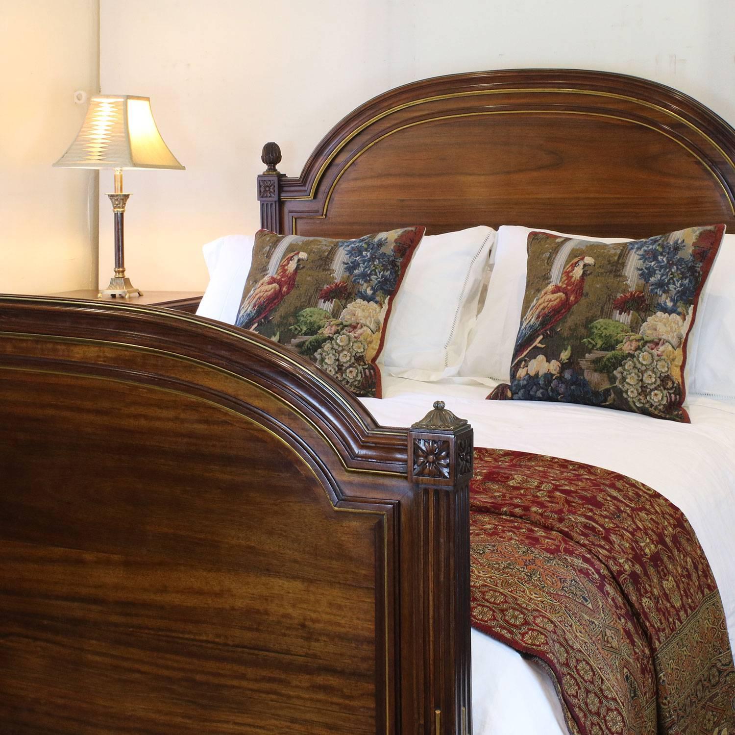 A mahogany bed with fine deep patina, acorn finials and brass string work.

This bed accepts a British king-size or American queen-size (60 in wide) base and mattress set.

The price is for the bedstead alone. The base, mattress and linen are