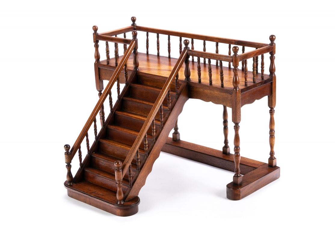 A well made solid wood eight step staircase with fine turned open sides and turned landing top supports, all with ball newel posts. With tall turned supports on the sides below the landing structure on a sturdy U shaped base.
Measures: Length 18