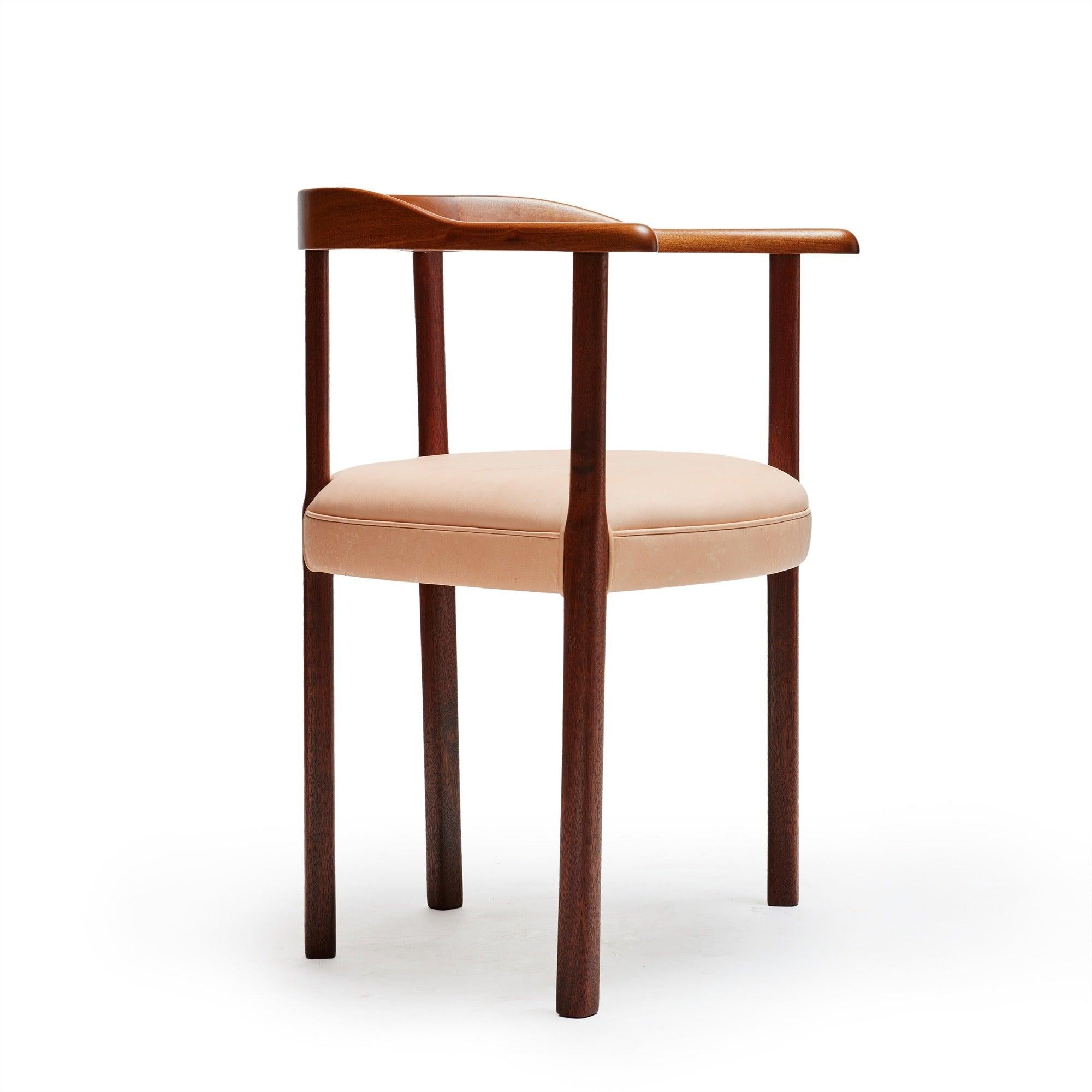 A mahogany armchair with a natural leather upholstered seat.