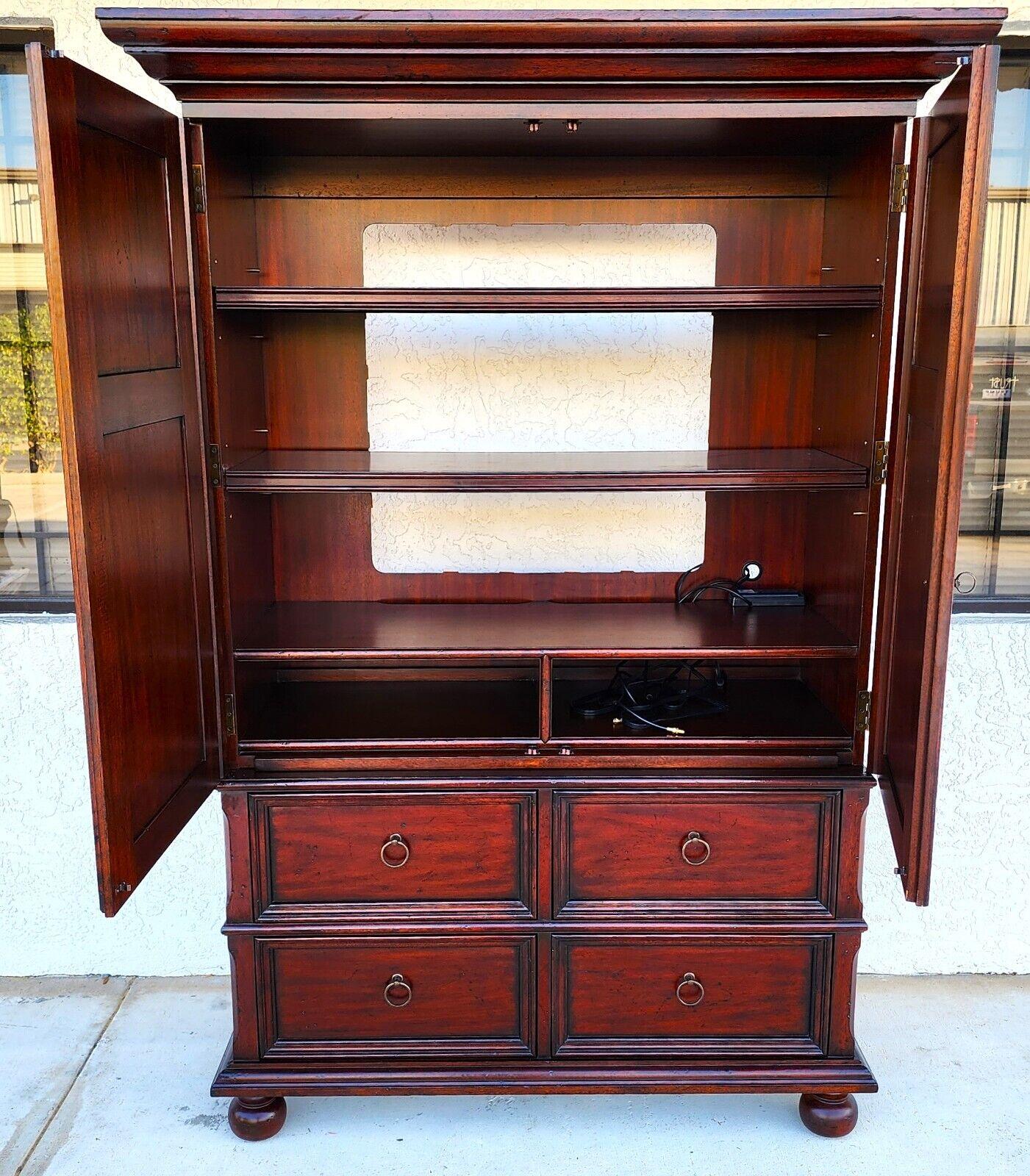 Offering one of our recent Palm Beach Estate fine furniture Acquisitions of A
Mahogany Armoire by Ralph Lauren
Featuring 4 bottom drawers and 2 adjustable and removable shelves.
It's a 2 piece unit so it is easy to move.

Approximate