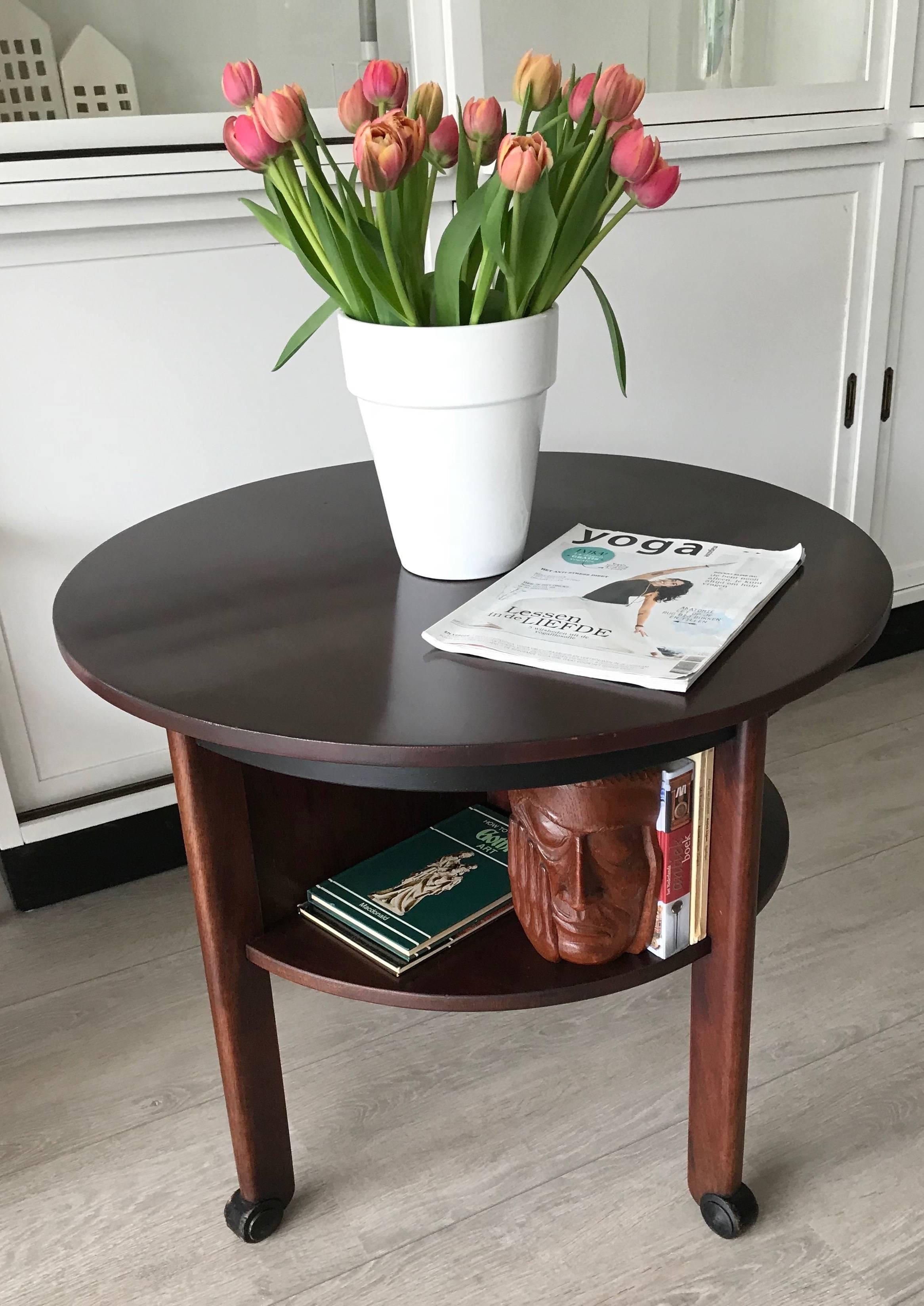 Unique and good size Art Deco table. 

This stunning 1920s Art Deco coffee table is in good condition. This fine specimen stands on, so called, ebonized wooden feet and the design of those feet is beautiful too. The shelves that make the extra tier