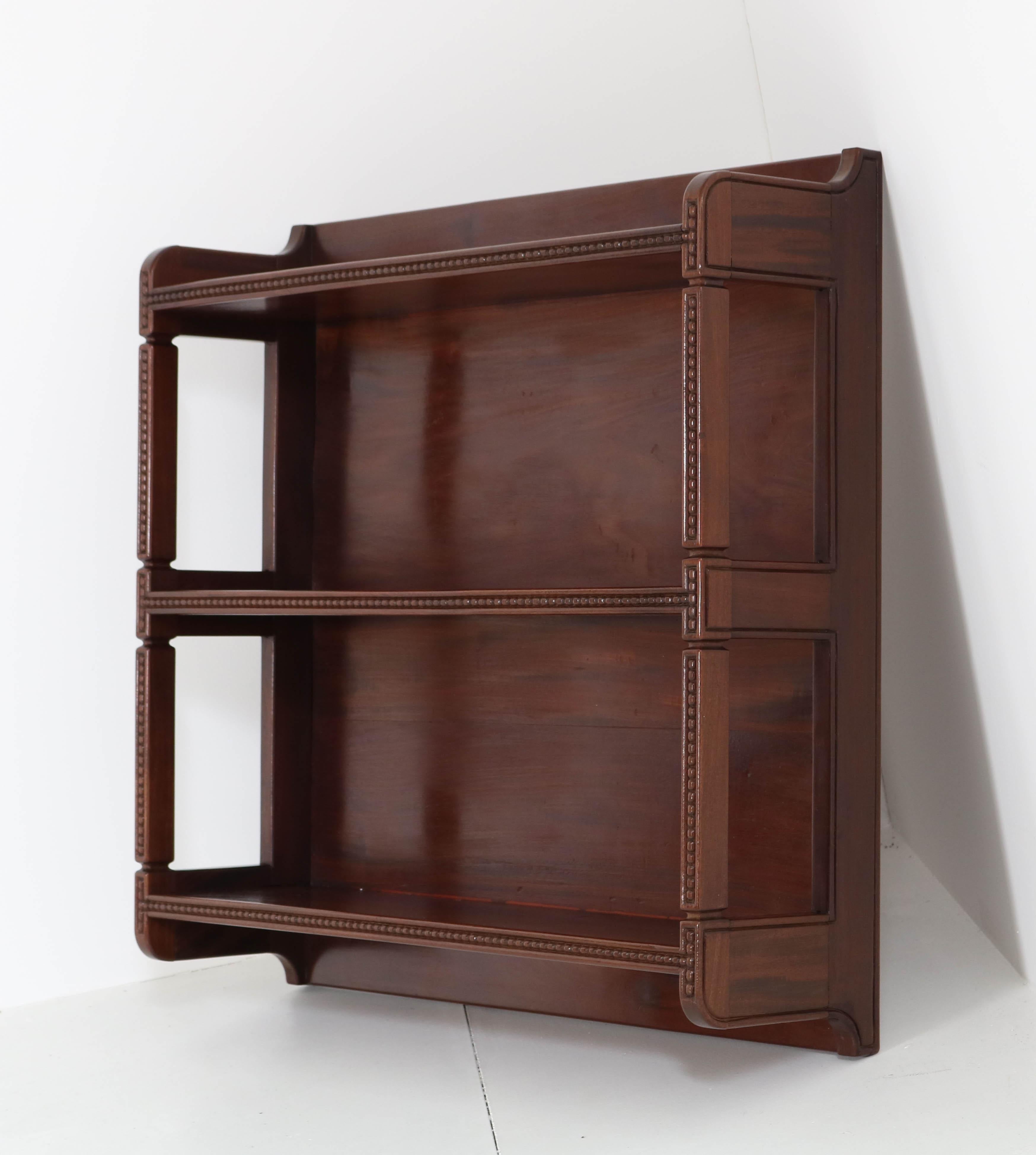 Magnificent and rare Art Nouveau Arts & Crafts hanging shelf étagère.
Design by K.P.C. de Bazel.
Striking Dutch design from the 1900s.
Solid mahogany with nice lining.
In very good condition with minor wear consistent with age and