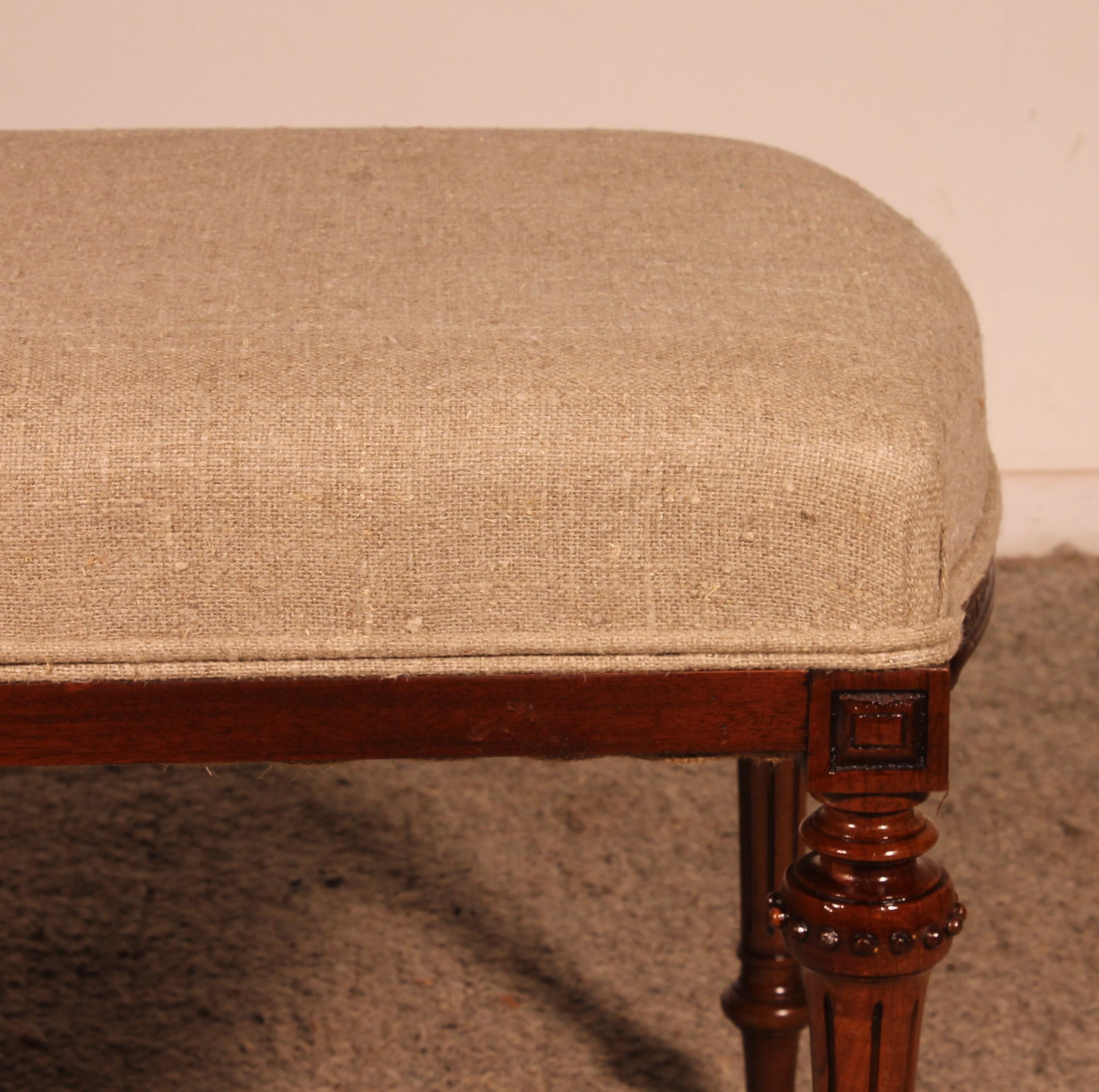 British Mahogany Bench From The 19th Century Covered With A Linen Fabric