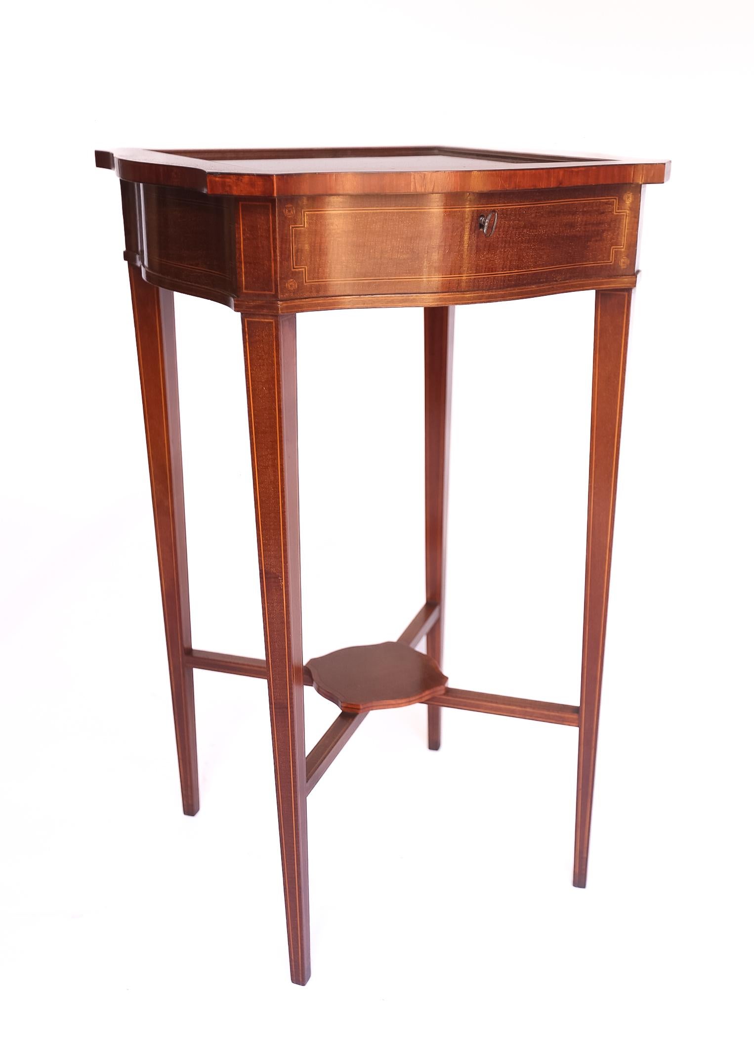 Mahogany & inlaid  Bijouterie Cabinet 
Stamped Edwards & Roberts 
Glazed hinge top, with working lock & key
Satinwood cross banding, boxwood line,
Foliage & bell flower inlay
Serpentine Shaped sides &
Tapering legs with Boxwood line & inlay