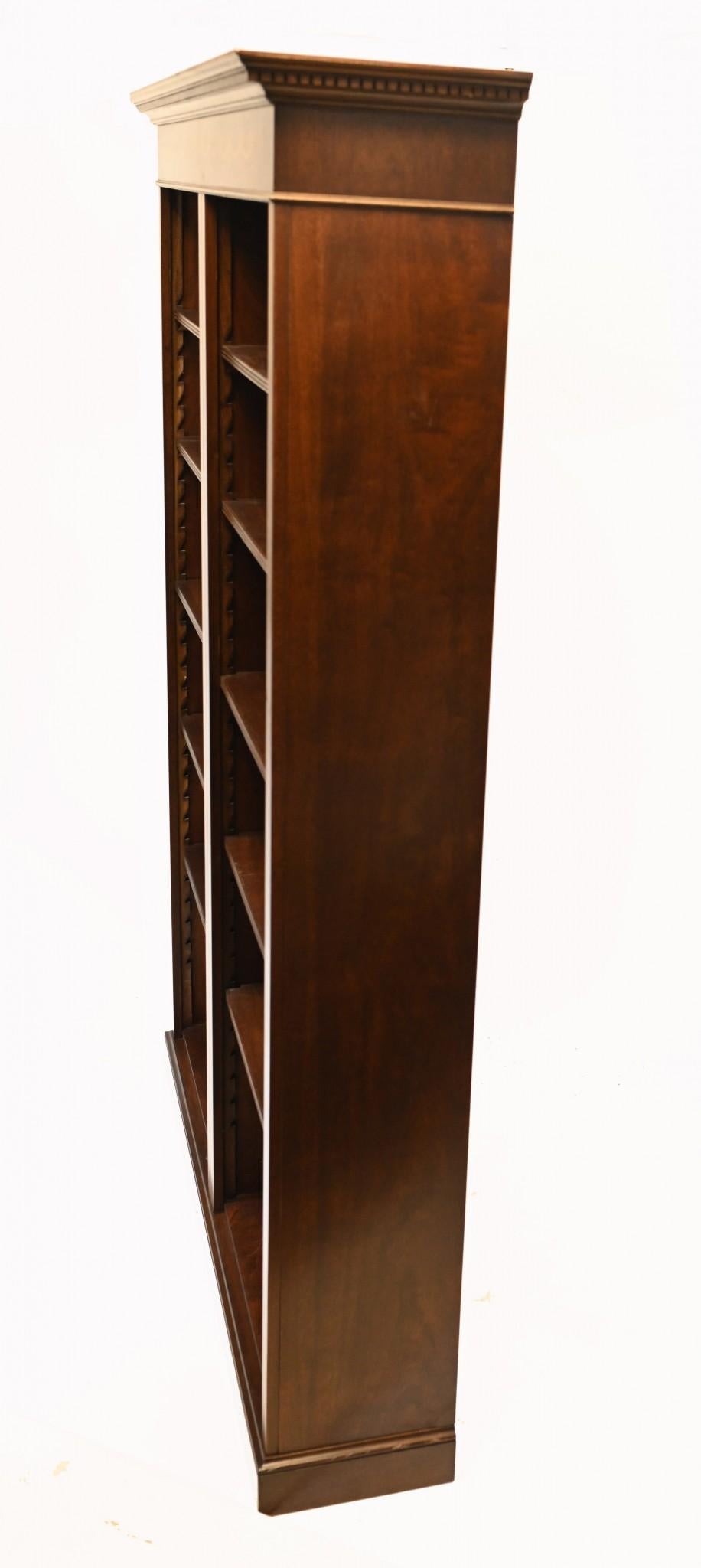 You are viewing a gorgeous double fronted English mahogany openfront bookcase with Sheraton inlay. I hope the photos do this stunning piece some justice, it is certainly more impressive in the flesh.

The piece has an air of classical refinement to