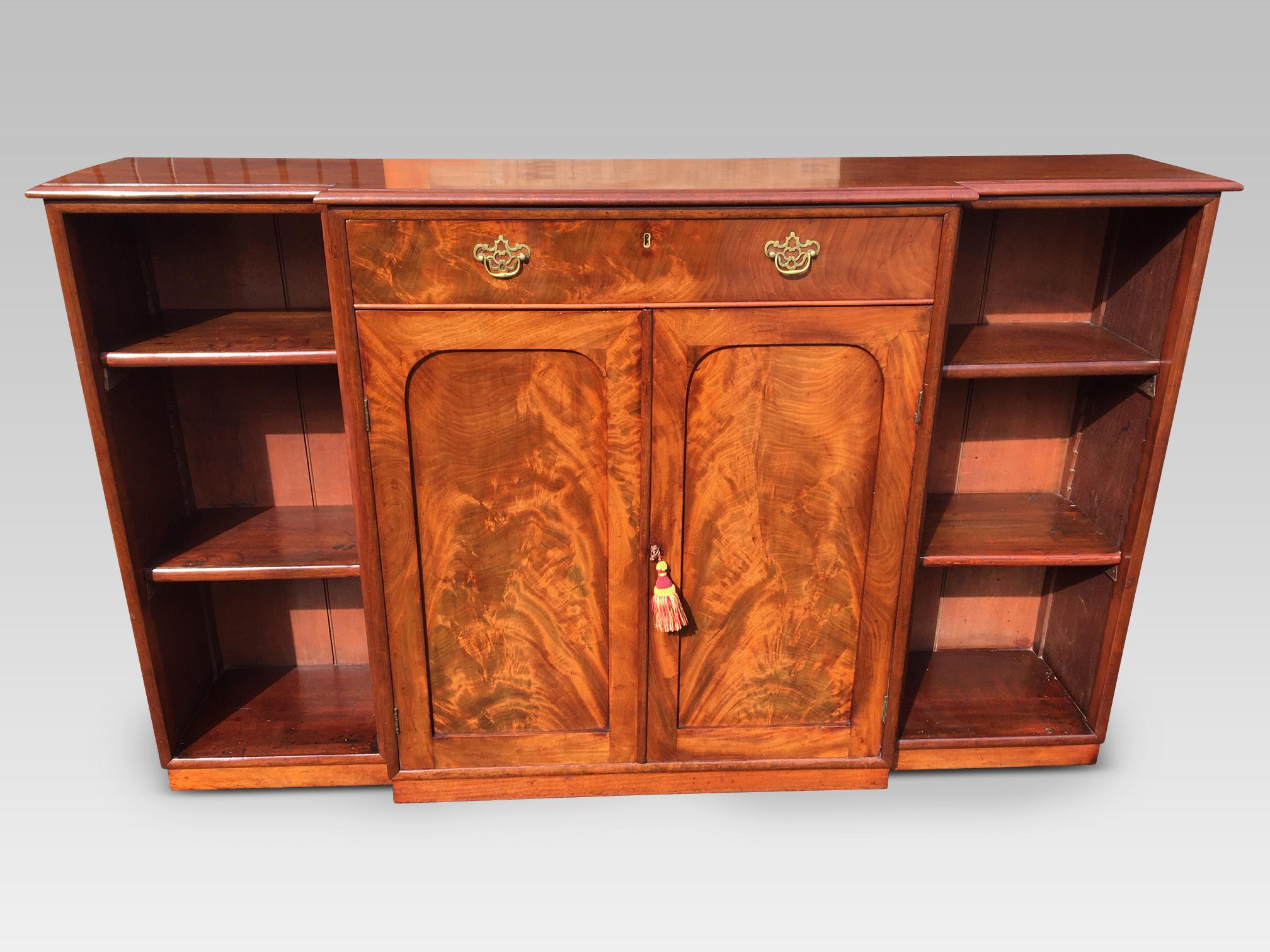 Attractive mahogany break fronted bookcase, English, circa 1860.
This is a good solid antique mahogany breakfront bookcase with adjustable
shelves, a central drawer and panel doors in the base. The quality of this item is
delightful and the
