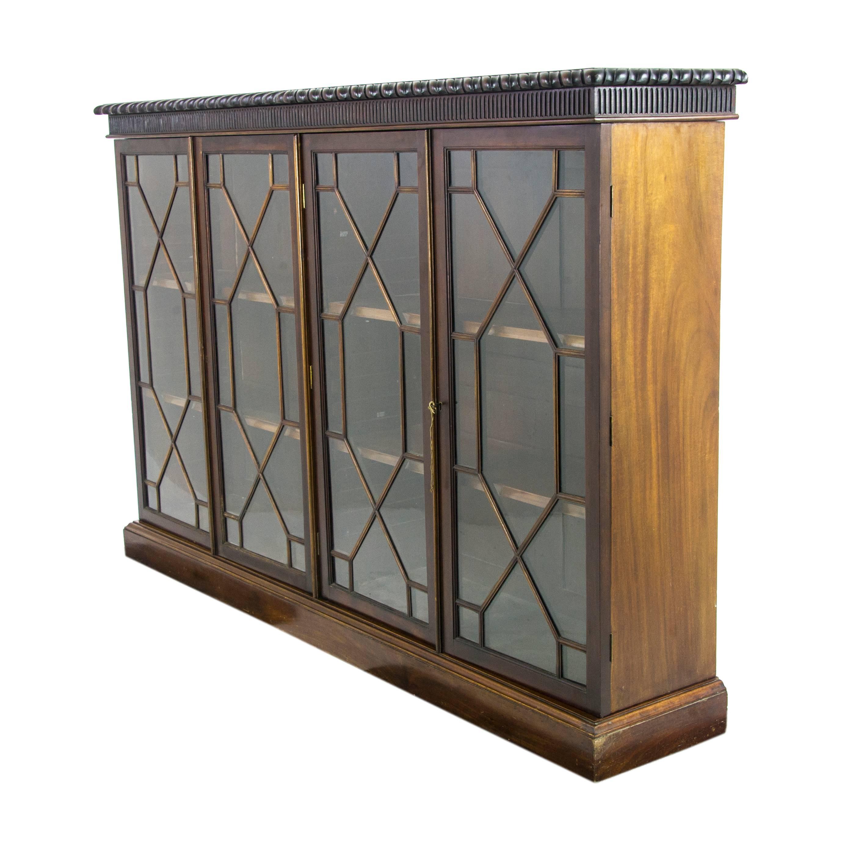 Walnut bookcase, antique bookcase, Scotland 1910, Antique Furniture, B1000.

Scotland, 1910.
Solid mahogany
Original finish
Rectangular top with gadroon
Carved at edge
Four astragal doors with working lock and key
Each door encloses fully adjustable