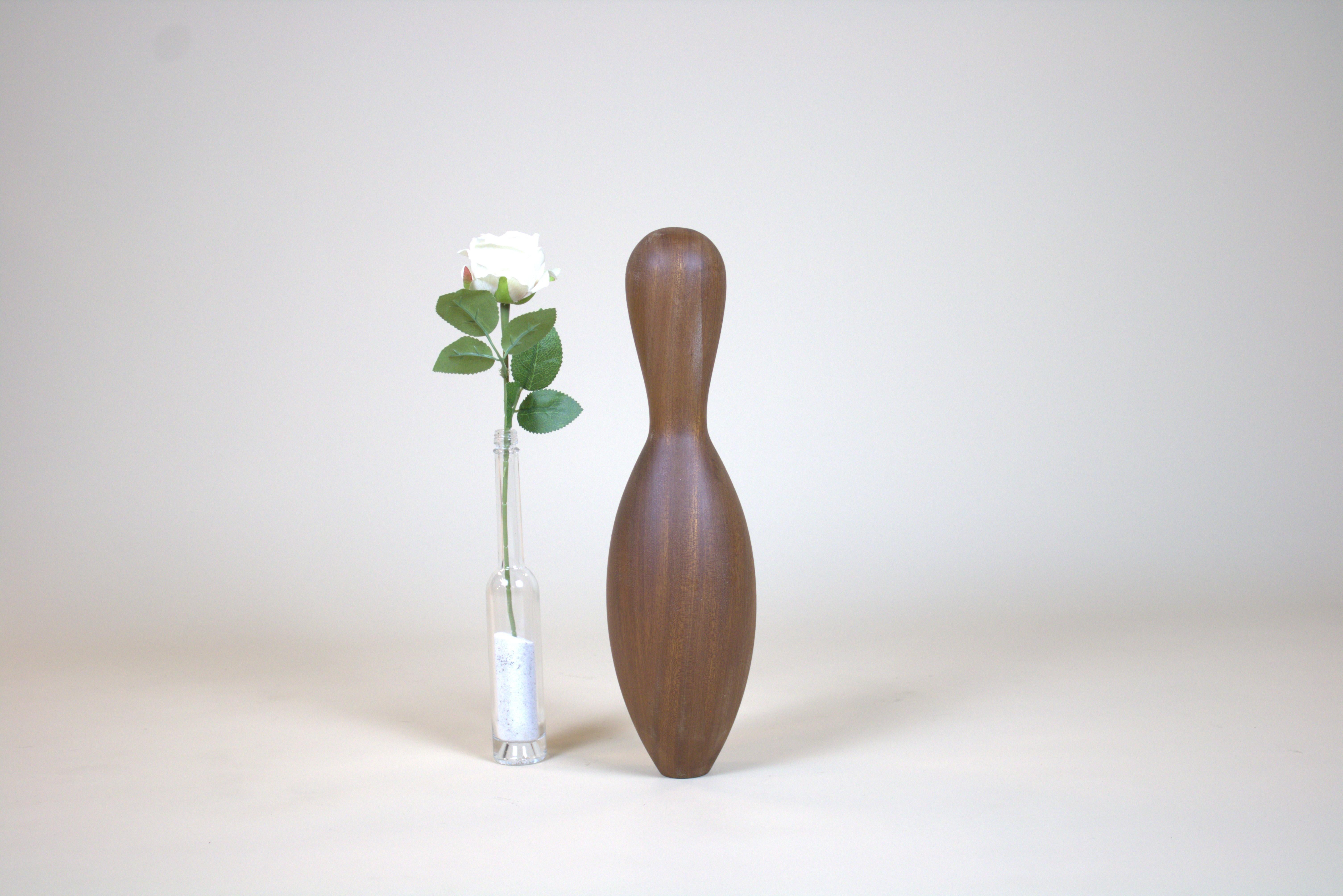 Handmade Mahogany Bowling Pin
Carved from solid mahogany, this one-of-100 bowling pin transforms a familiar sporting object into a sculptural work of art. The rich reddish-brown wood reveals a fine, straight grain that shimmers with depth under a