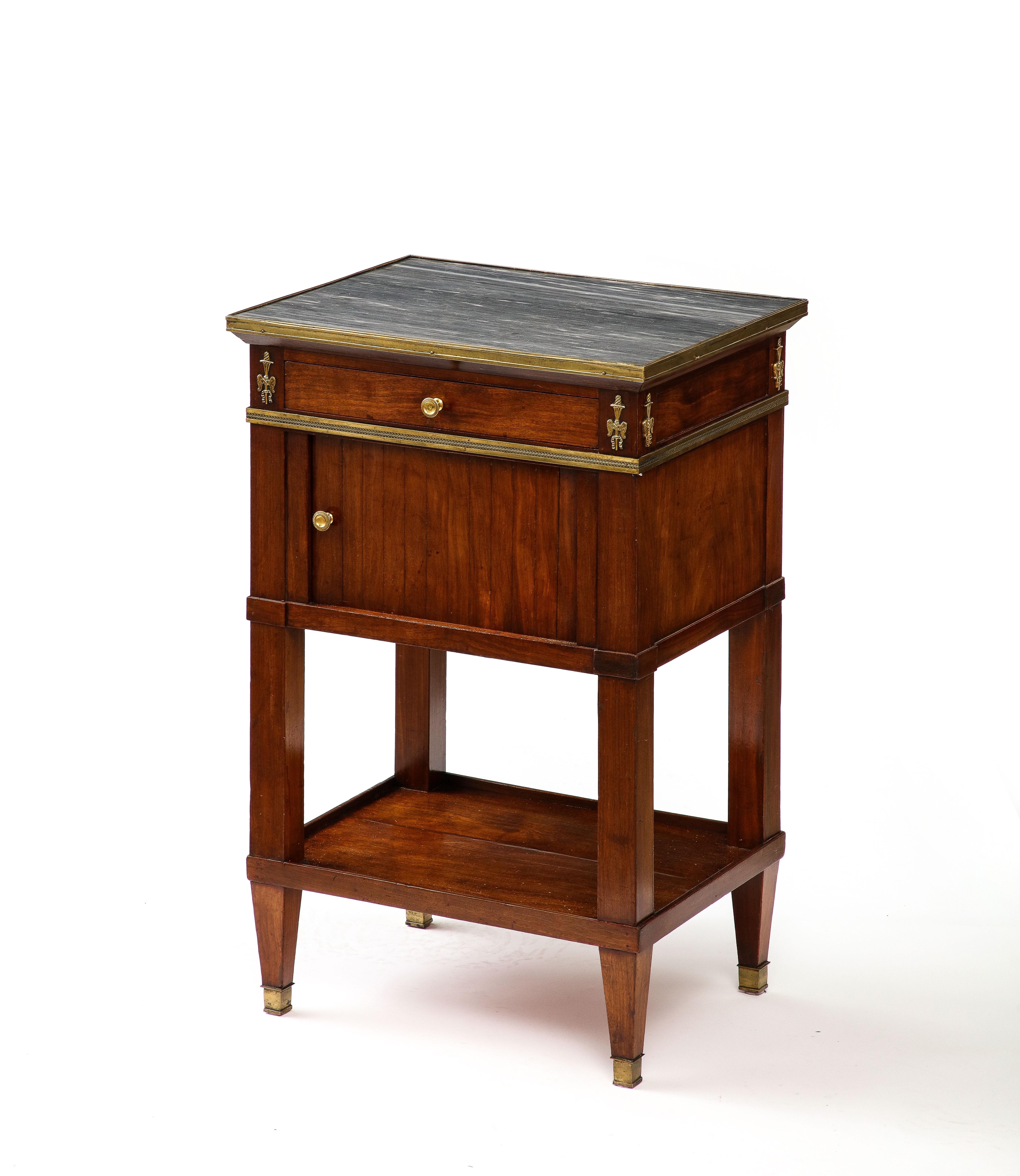 Stately mahogany nightstand with a tambour door, and brass and marble detailing.