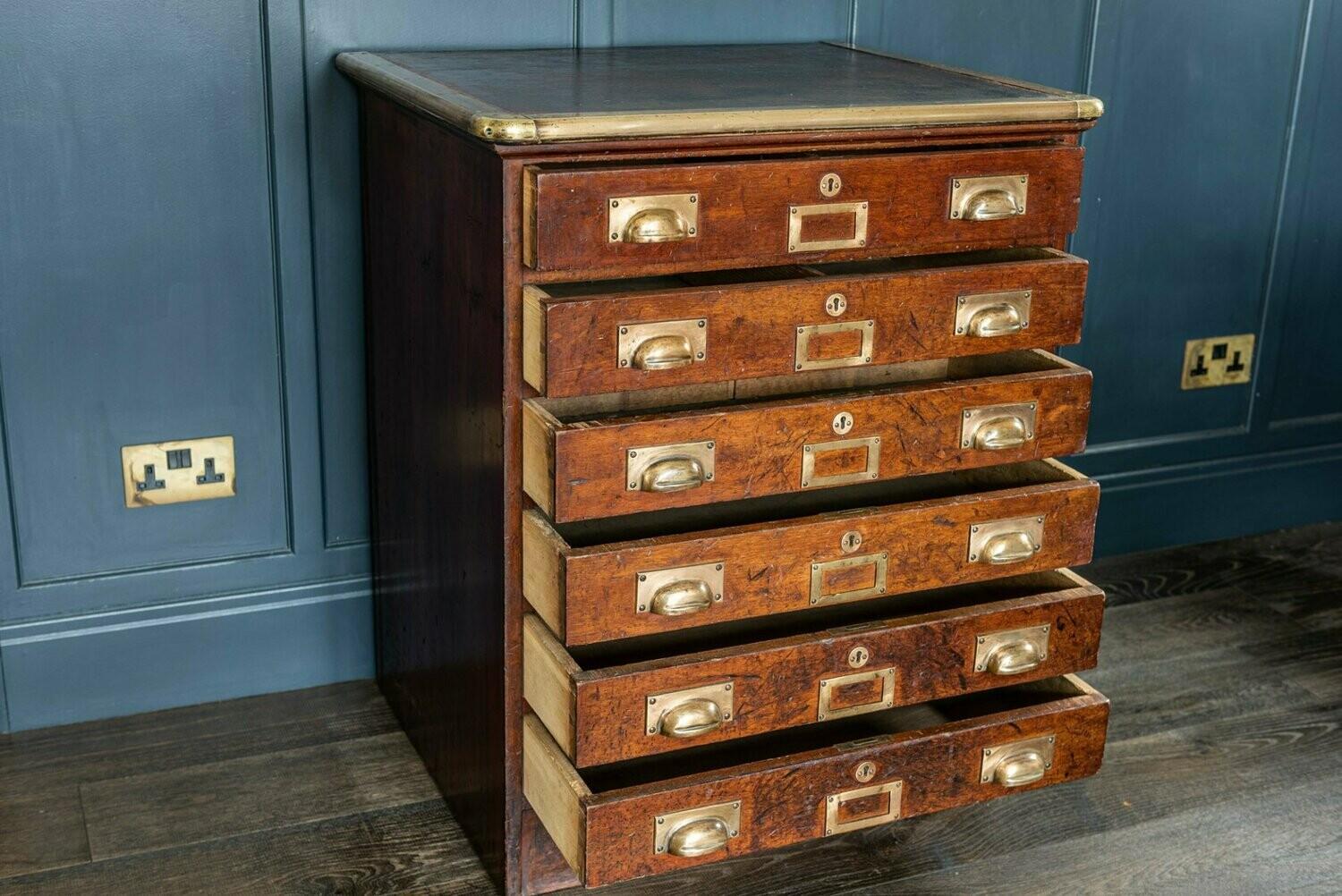 Mahogany brass capped bankers drawers. English, circa 1920

Formerly bankers drawers and subsequently used as workshop drawers which has created an amazing wear and patination. Unusual brass/bronze capping to the oxblood leather inset top.
