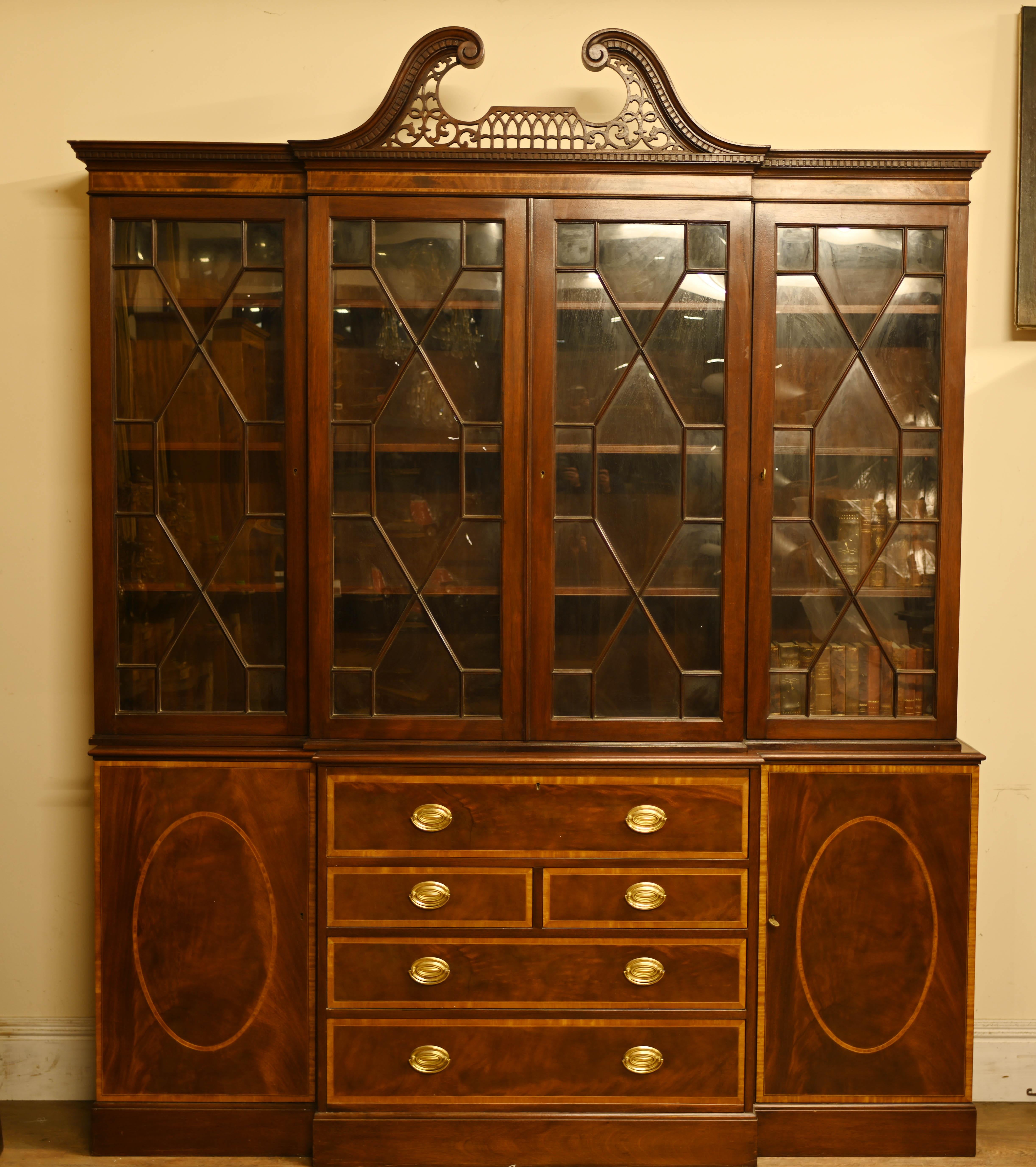 Elegant mahogany breakfront bookcase in the Sheraton manner
The piece is antique circa 1920
Features a secretaire pull out desk section in the middle
Lots of storage space on this refined piece of English furniture
Viewing by appointment