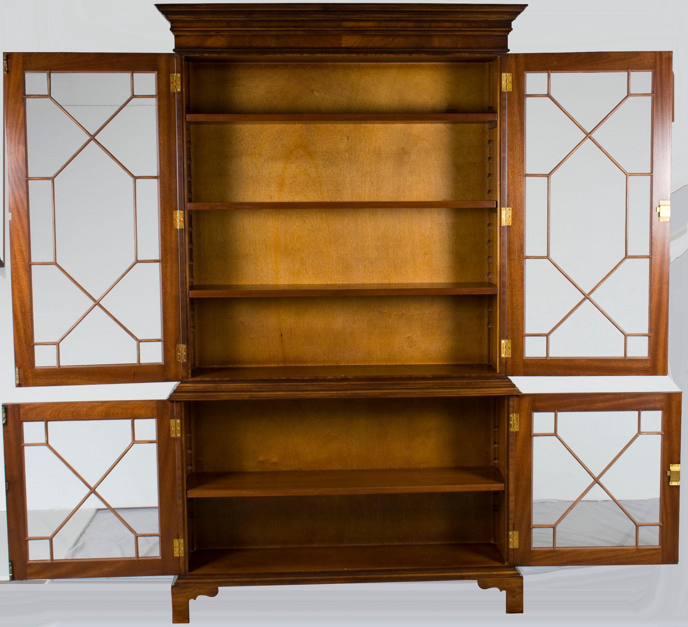 This exquisite flame mahogany astragal glass bookcase is a new reproduction handmade in England by a third-generation cabinetmaker. The astragal glass moulding sets this gorgeous bookcase apart, giving it a classy look that, when combined with the
