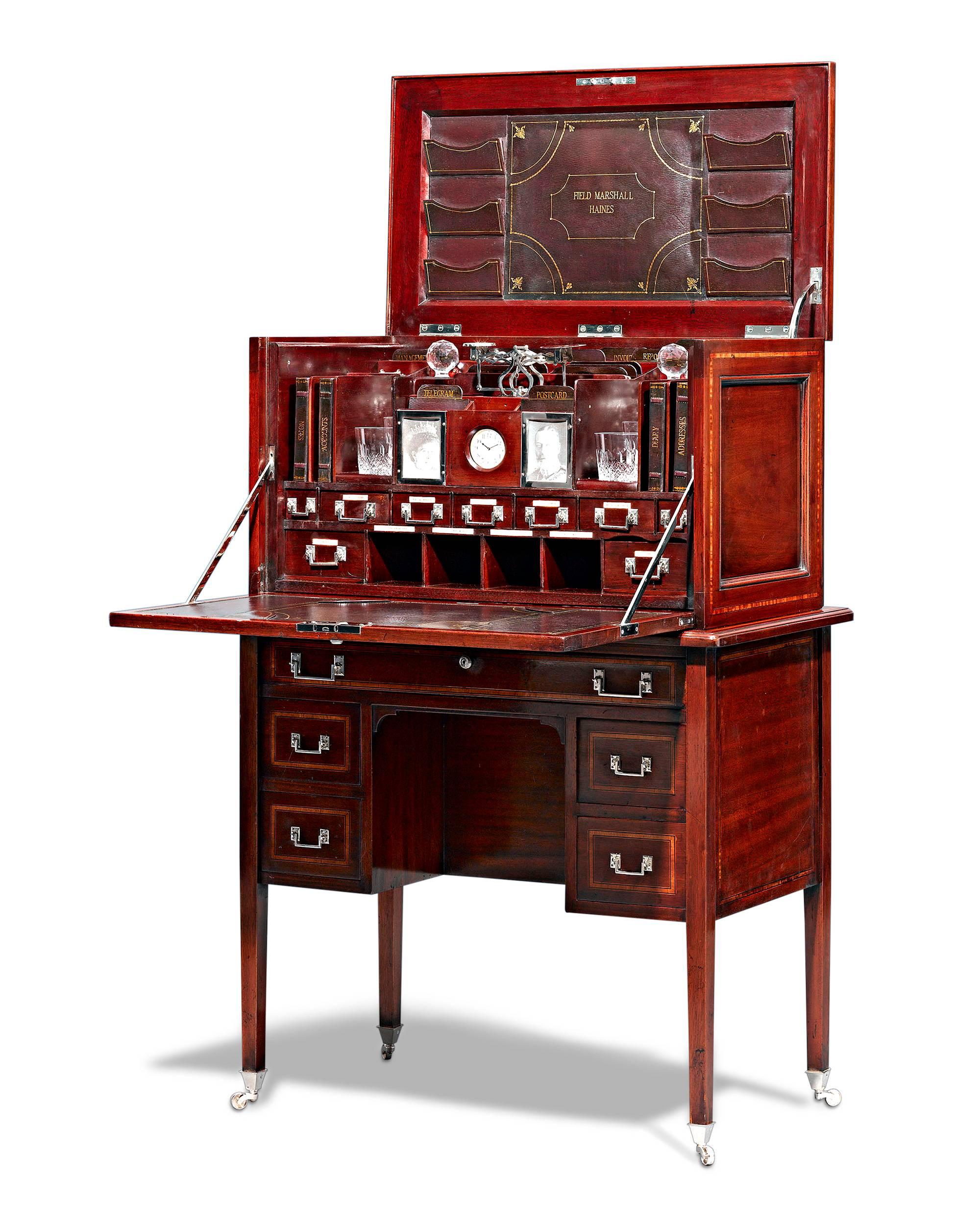 This extraordinary and rare English desk is an impeccable example of English campaign furniture. Crafted of mahogany, this compact desk was in service under Field Marshal Sir Frederick Paul Haines, the celebrated military officer known for his