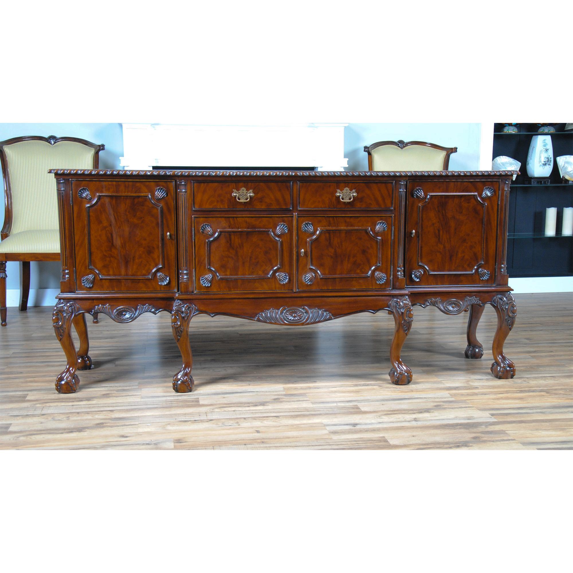 The Mahogany Buffet is a Chippendale inspired piece of furniture and closely matches our Mahogany Chippendale Breakfront. The bank of four dovetailed drawers align over the four figural veneered doors which conceal large storage areas, all resting
