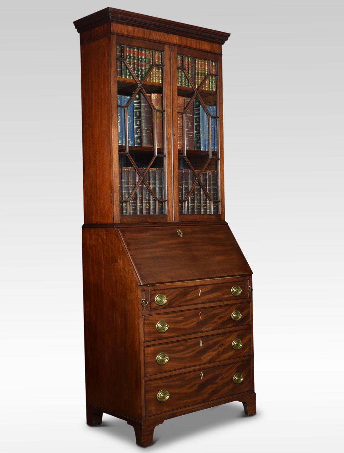 Mahogany bureau bookcase of compact proportions, the upper section fitted with two astragal glazed doors opening to reveal two adjustable shelves. The base section with fall flap supported on side lopers, enclosing a green baize writing surface