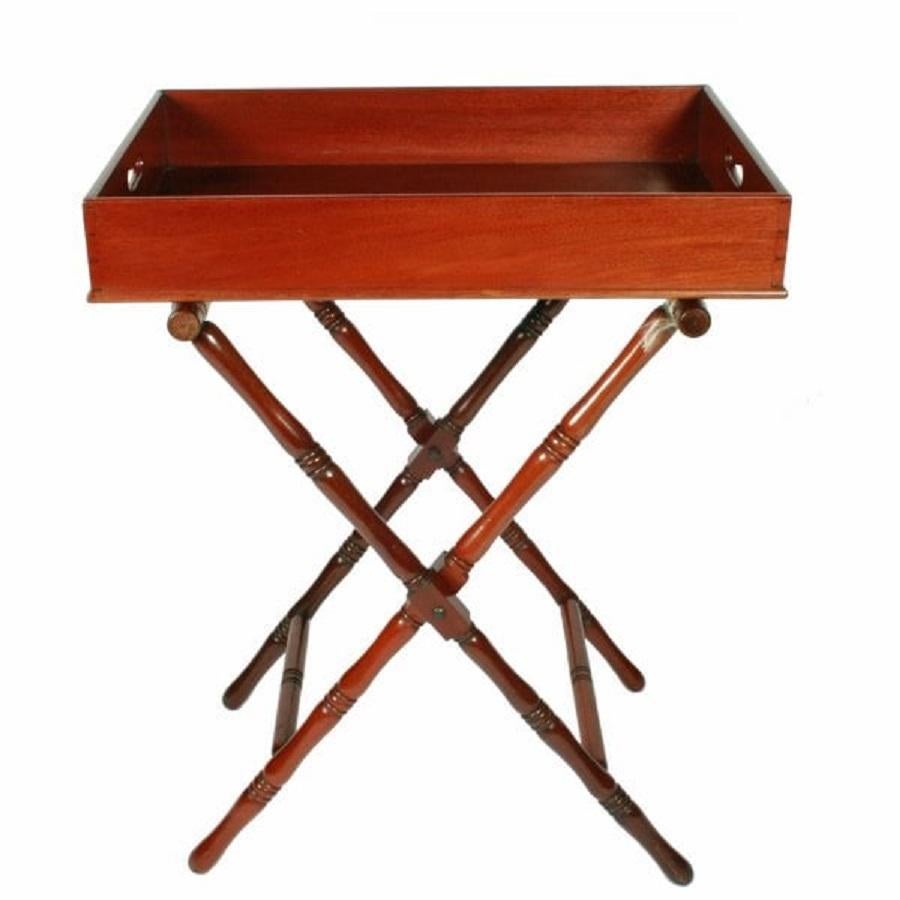 A mid 19th century Victorian mahogany butler's tray on a folding stand.

The mahogany tray is oblong in shape with two cut out carrying handles on the shorter sides.

The folding stand is constructed from turned mahogany and has turned