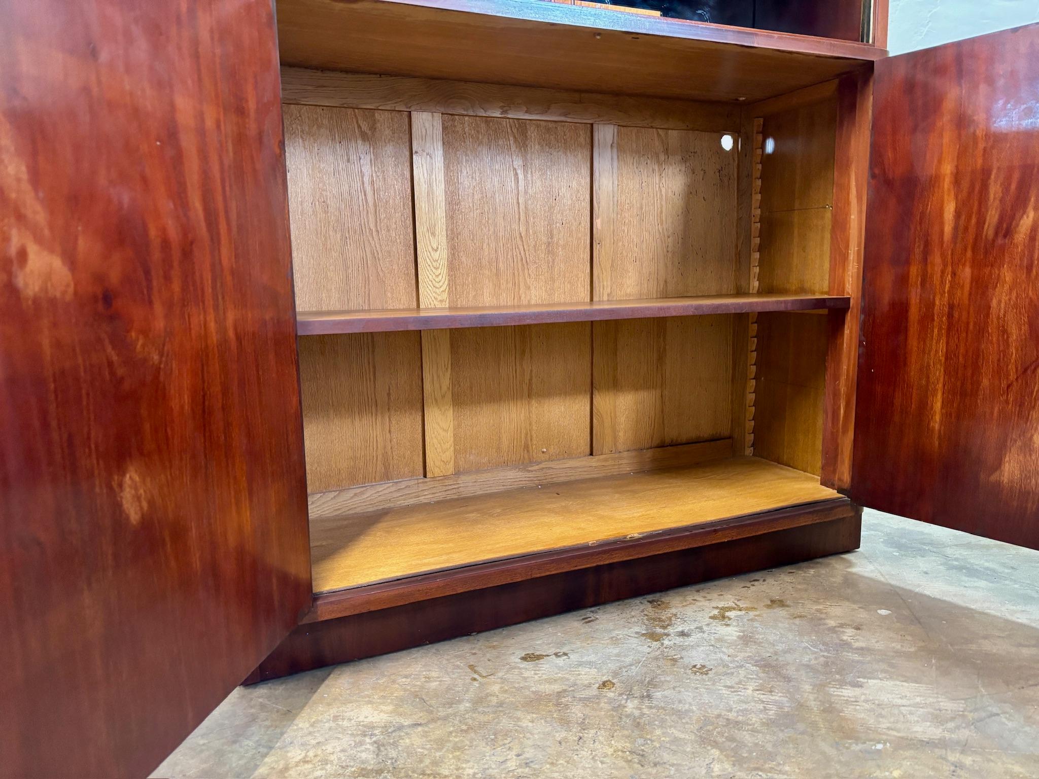 High quality two-door cabinet with open shelf on top. Single wood shelf on large bottom section. Sliding glass doors can be added to mirrored top section.

Hole has been drilled in top shelf for cord access. (see photo for details)

47 1/2
