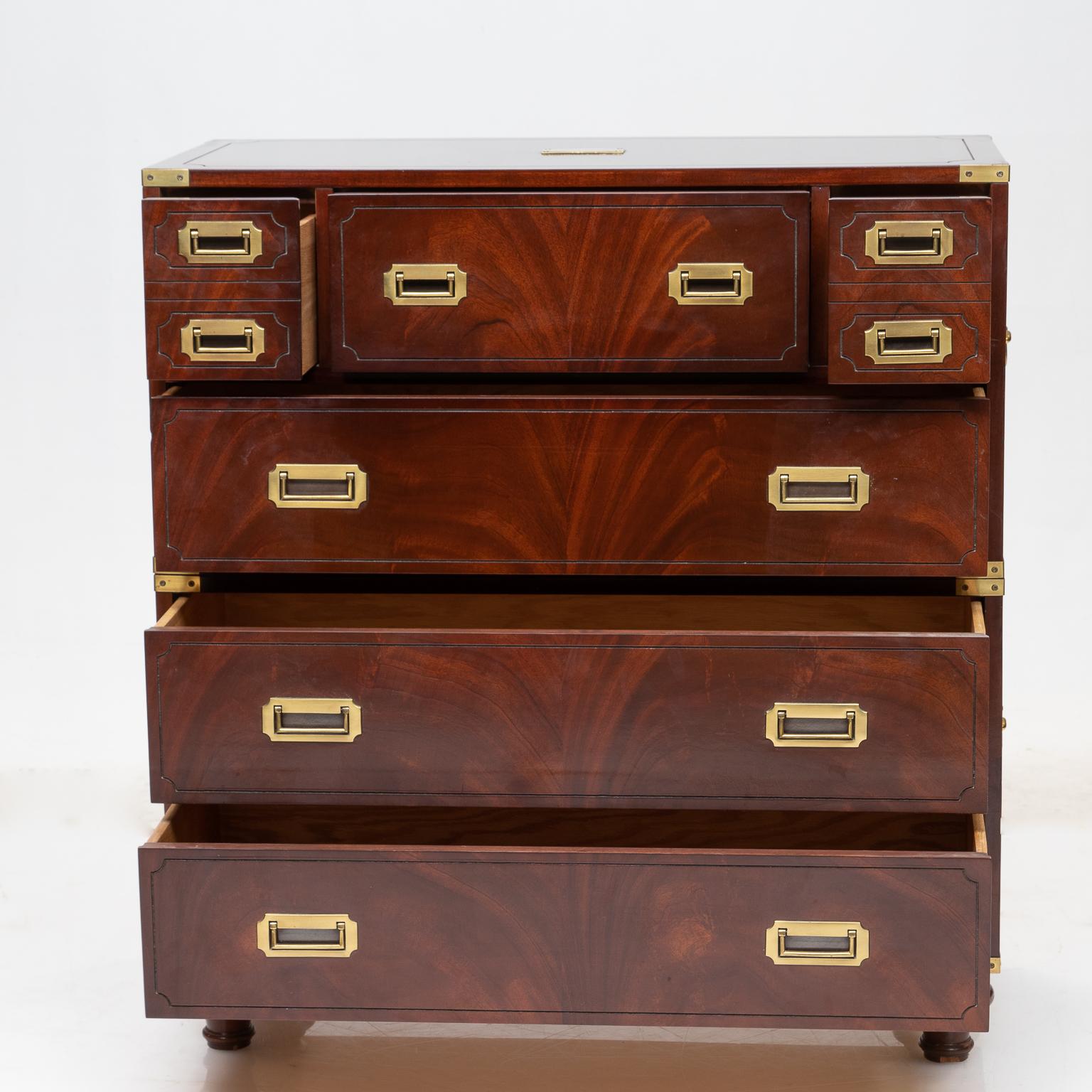 Mahogany campaign style chest of drawers with quality brass strapping, handles and an un-engraved brass plaque on the top. Beautiful flamed mahogany. Turned feet. Functions very well. Made by Hickory Chair Company.