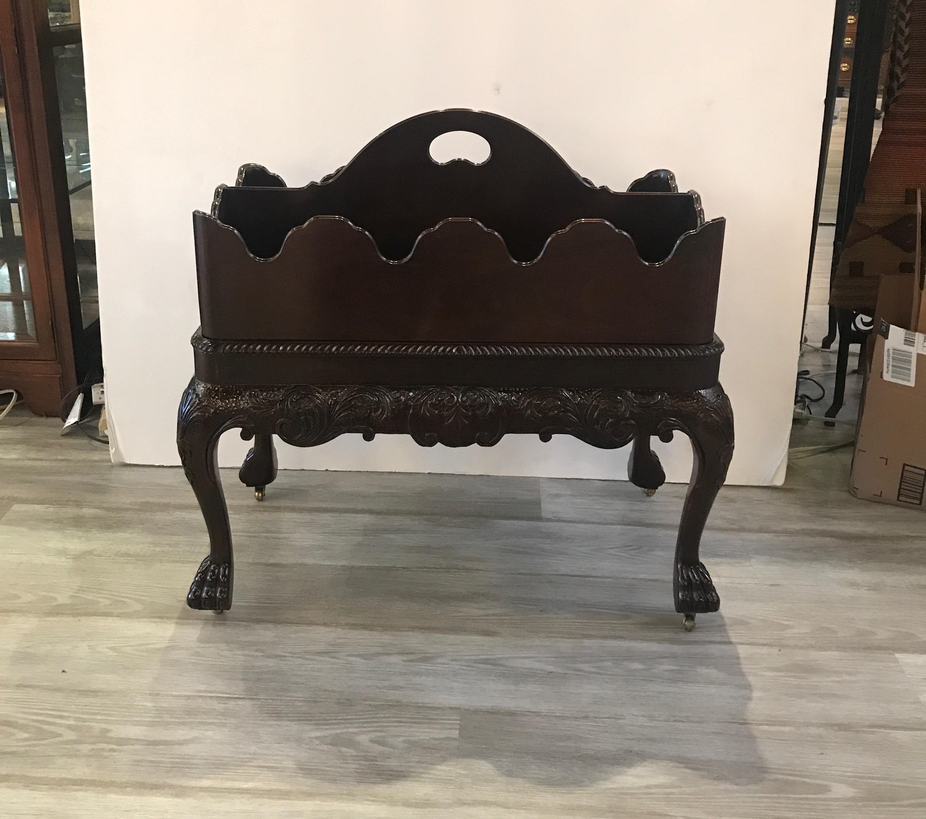 An exquisite mahogany Chippendale style Canterbury magazine rack by Baker Furniture. Carved relief apron, removable tray top, gadrooned edge, cabriole legs and paw feet on casters grace this outstanding piece. Very good condition. The dimensions of