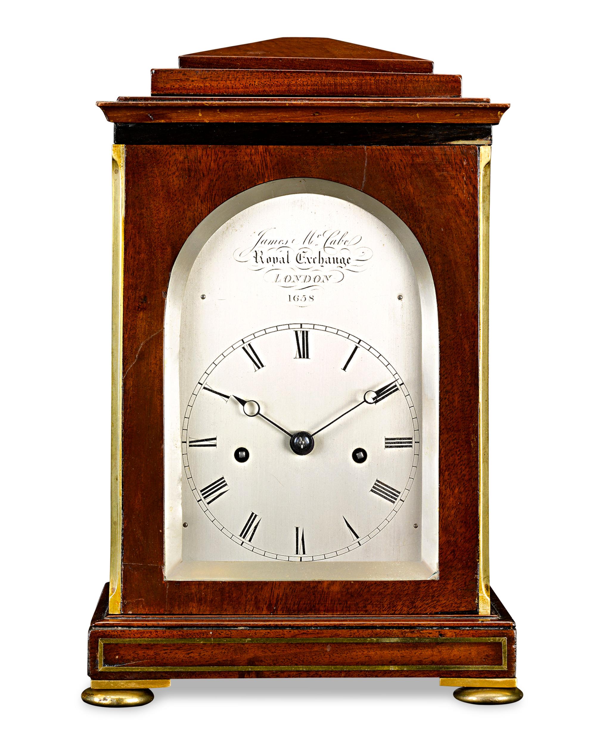 This solid mahogany traveling clock with balance wheel escapement was crafted by celebrated London clockmaker James McCabe for London’s Royal Exchange. Known for exquisite workmanship and precision, McCabe timepieces were owned by notable figures,