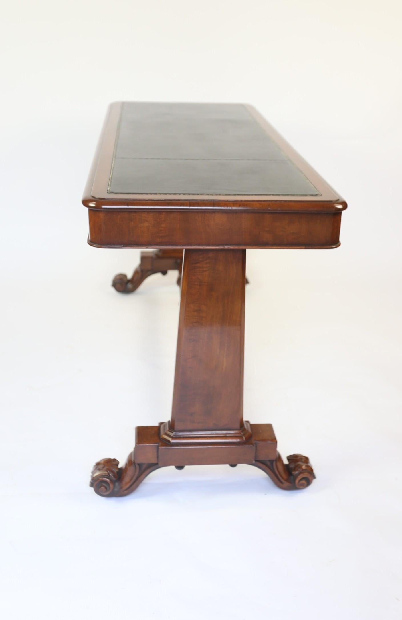 William 1V Period  Mahogany leather top Library table circa 1830s
Mahogany top with thumb mould edge, with:
Black Leather inset top with Gold tooling detail
Plain Round cornered Apron
Pair Mahogany Tapered Slab end supports, 
Sitting on block