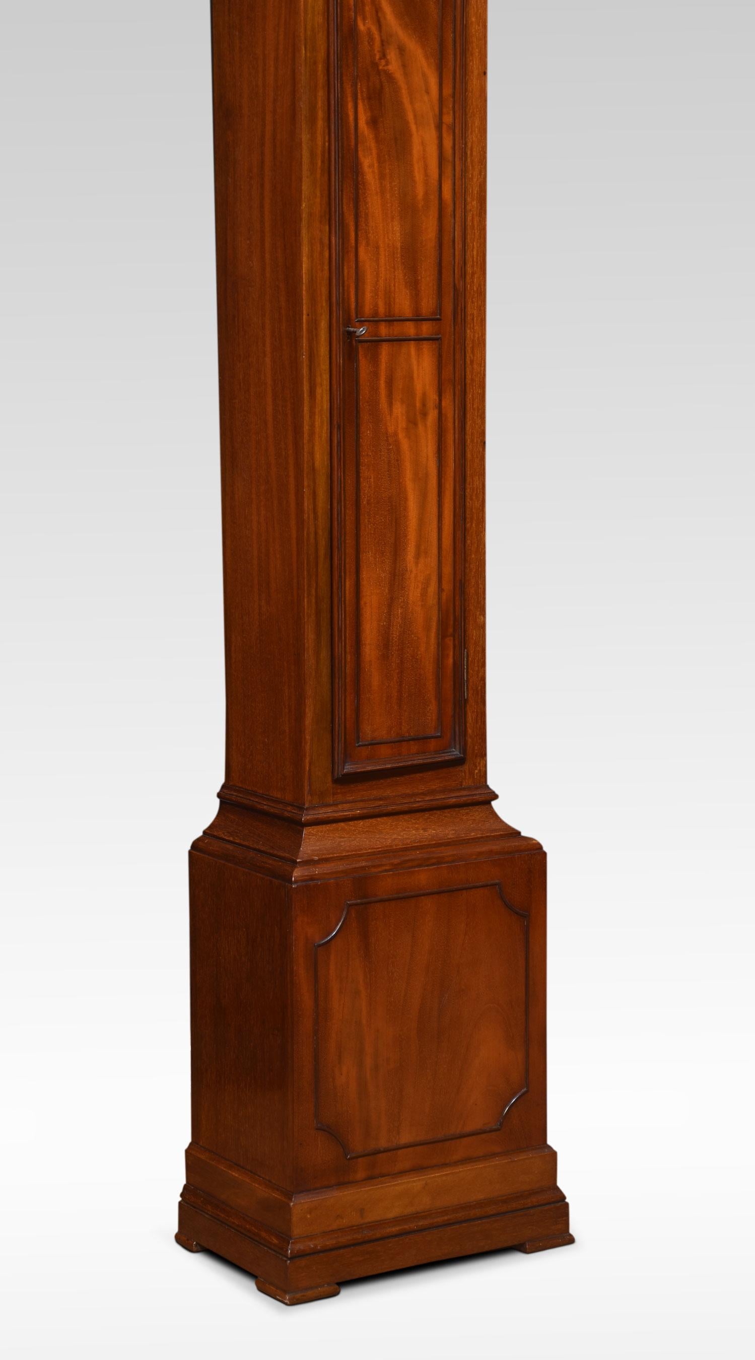 Mahogany cased grandmother clock, the moulded hood to the brass dial engraved with gilt-metal Roman numerals and decorated foliated face. The eight-day weight-driven movement chiming on a gong. The mahogany case with long rectangular door above