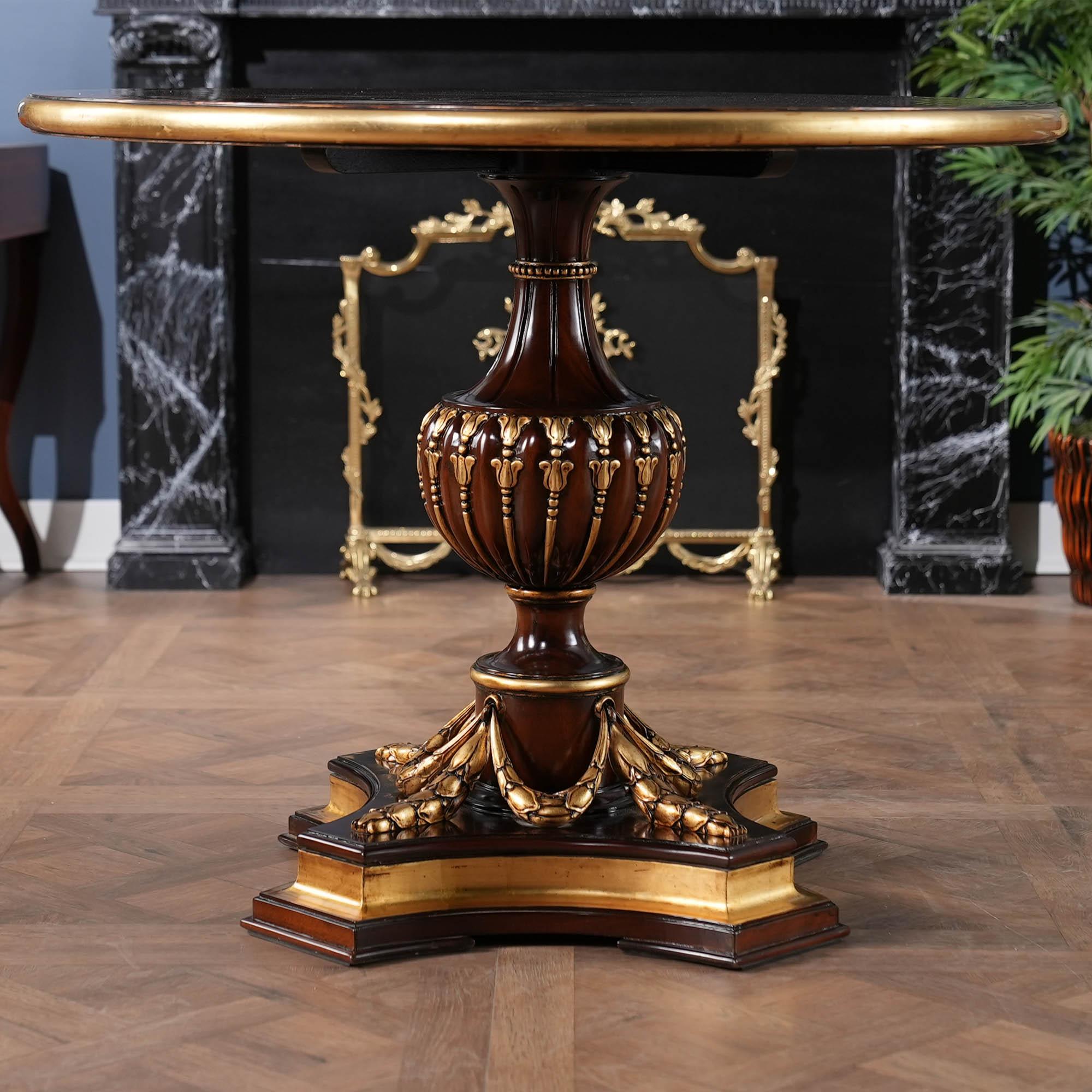A gorgeous, high quality Mahogany Center Table with plenty of presence to brighten up any room. Banded and figured mahogany top, hand carved solid mahogany base and real gold leaf accents all work together to create a table that could be the
