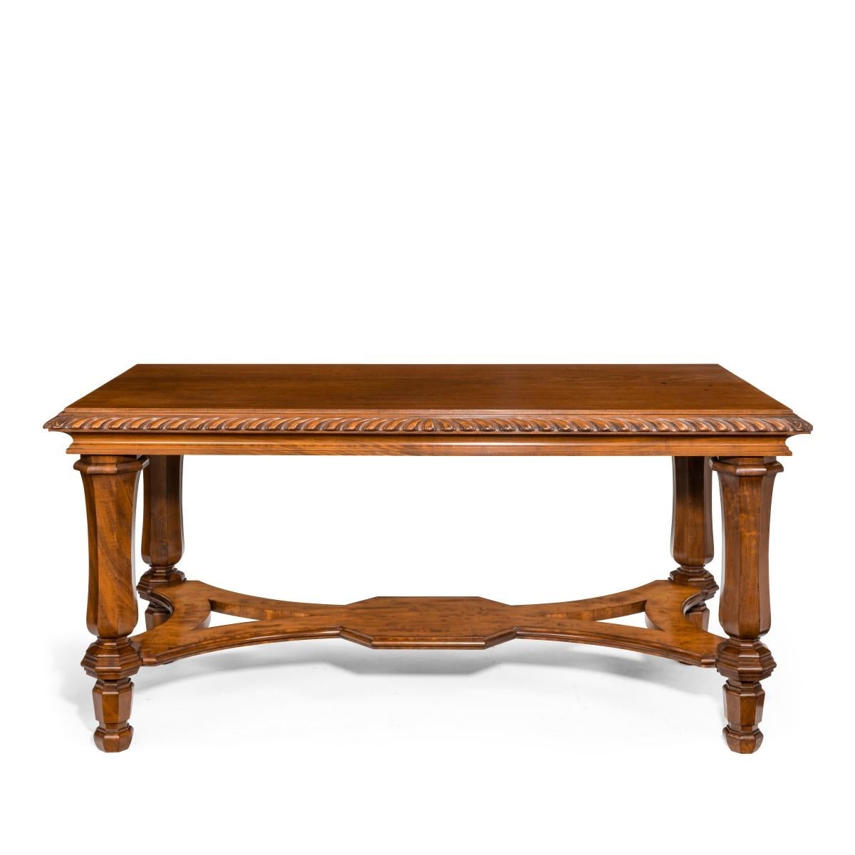 A mahogany centre table from Clumber Park, seat of the 7th Duke of Newcastle, the rectangular top with a gadrooned edge set upon four sturdy tapering and shaped hexagonal legs, joined to a flat X-frame stretcher, bearing an inventory label with a