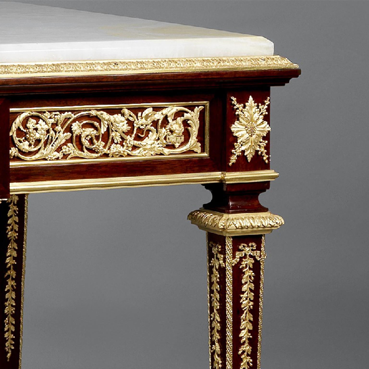A fine gilt-bronze mounted mahogany centre table with an onyx marble top by François Linke.

Linke Index number: 118 Linke title: 'Table Louis XVI, bois d'acajou bronze dorés.'

This fine gilt-bronze mounted mahogany table de milieu or centre