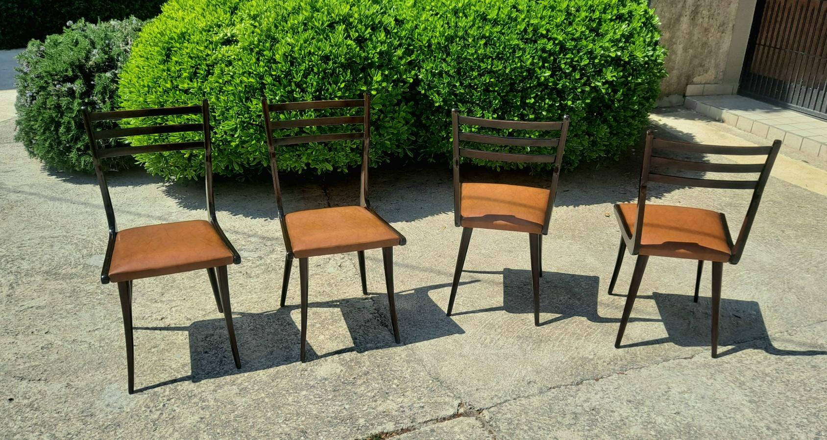 This is a original set of 4 chairs in style of Gio Ponti.
