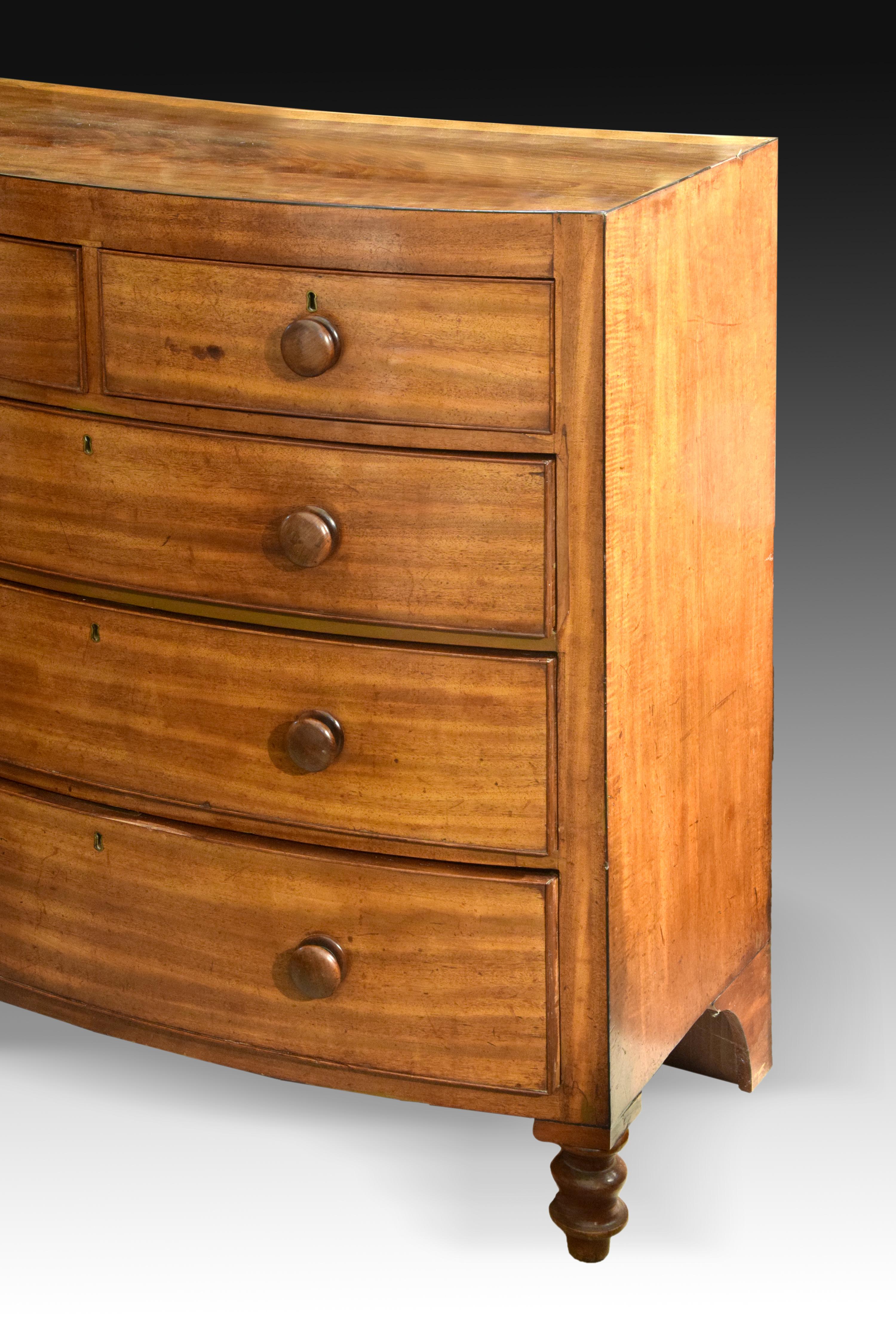 Chest of five drawers in mahogany wood, 19th century.
Two legs with discs and a curved back base support the chest of drawers, with a slightly curved front and whose five drawers (two smaller ones at the top) have a key lock and wooden knobs. The