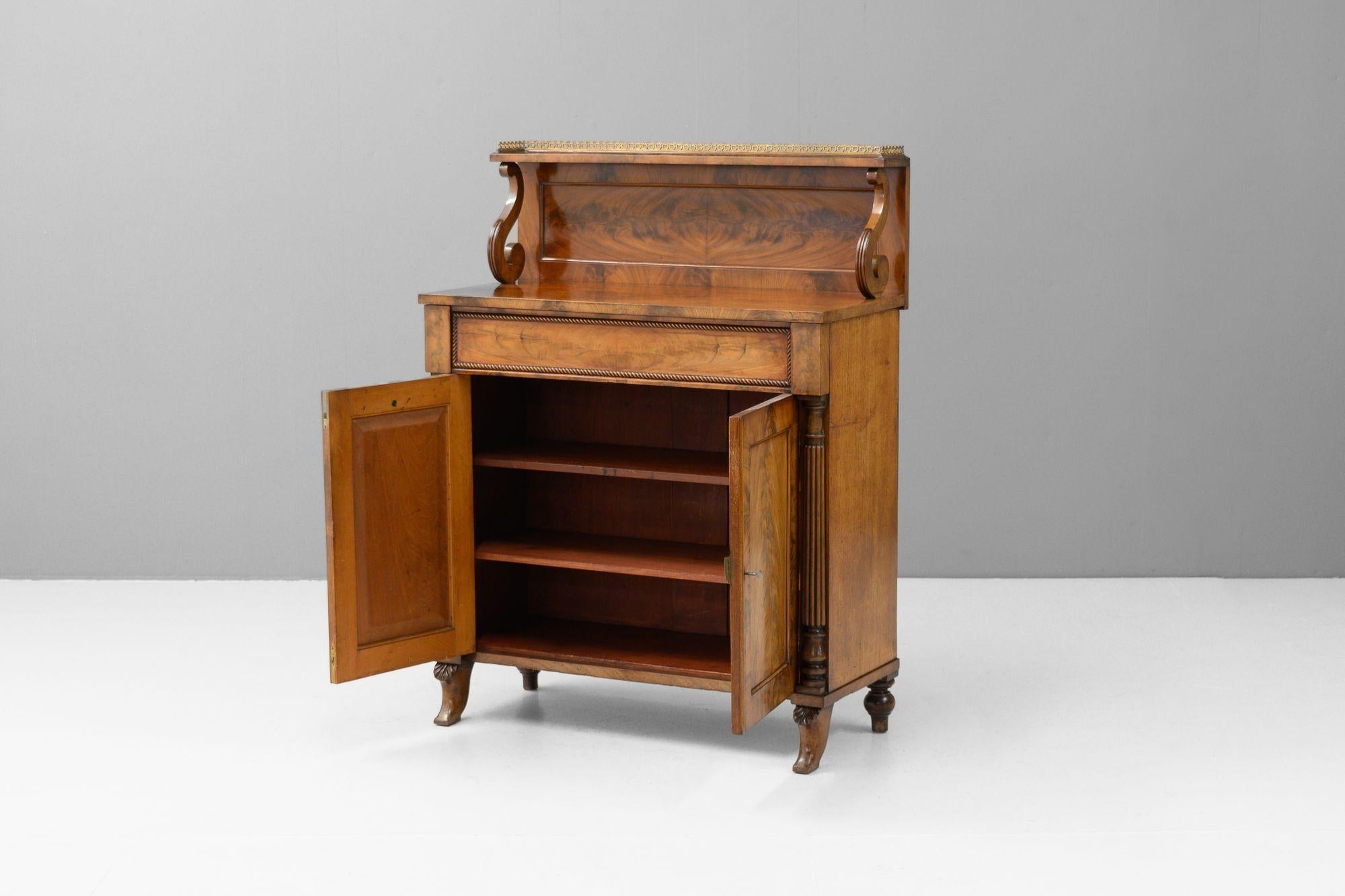 Mahogany two door chiffonier with brass galleried shelf. Circa 1800.
H 122cm x W 92cm x D 43cm