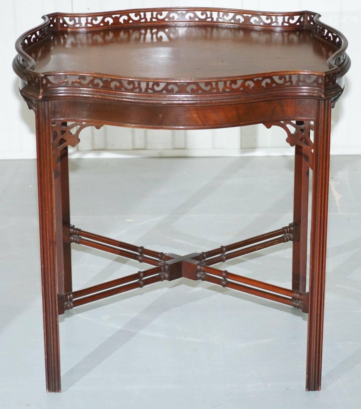 We are delighted to offer for sale this stunning antique fretwork carved Chinese Chippendale silver tray occasional table with famboo legs

In a modern sense, this would be classed as a large side table but the traditional use was for silver items