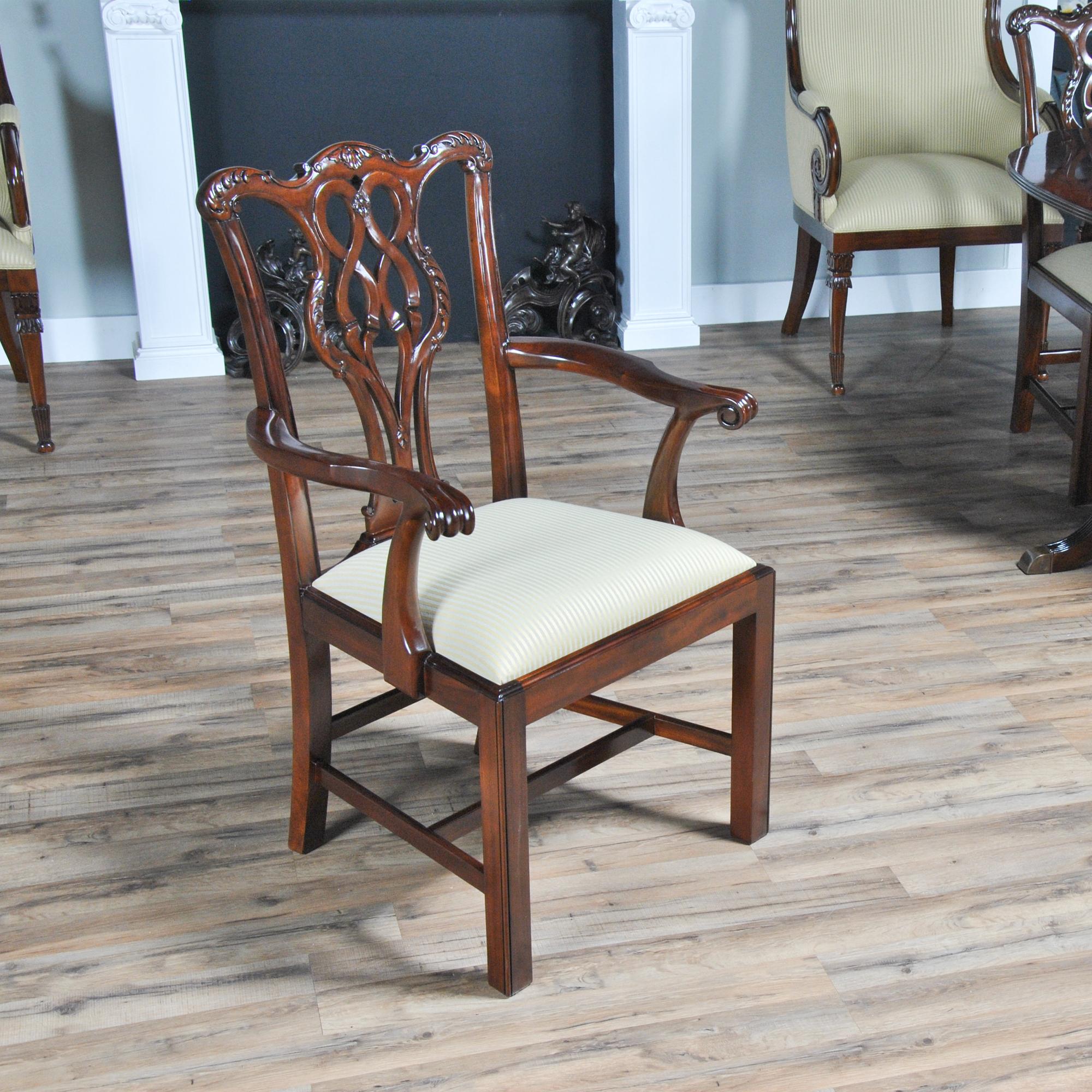 A hand carved, solid mahogany set of 10 solid Mahogany Chippendale Chairs with 2 arm chairs and 8 side chairs. Each chair has a serpentine crest rail and similar back splat, all hand carved from solid mahogany. The armchair features scrolled and