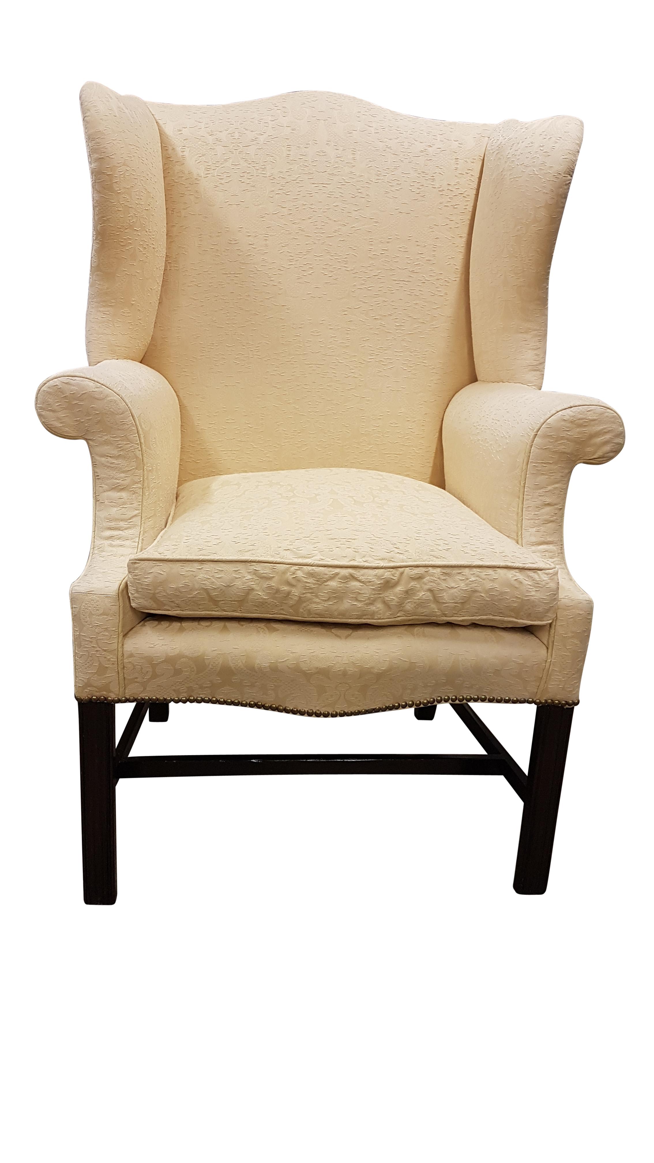 A grand and elegant early 20th century Chippendale revival camel topped wingback armchair with a serpentine front. This armchair is of a large scale so would comfortably fit a larger framed person. It has recently been fully reupholstered using high