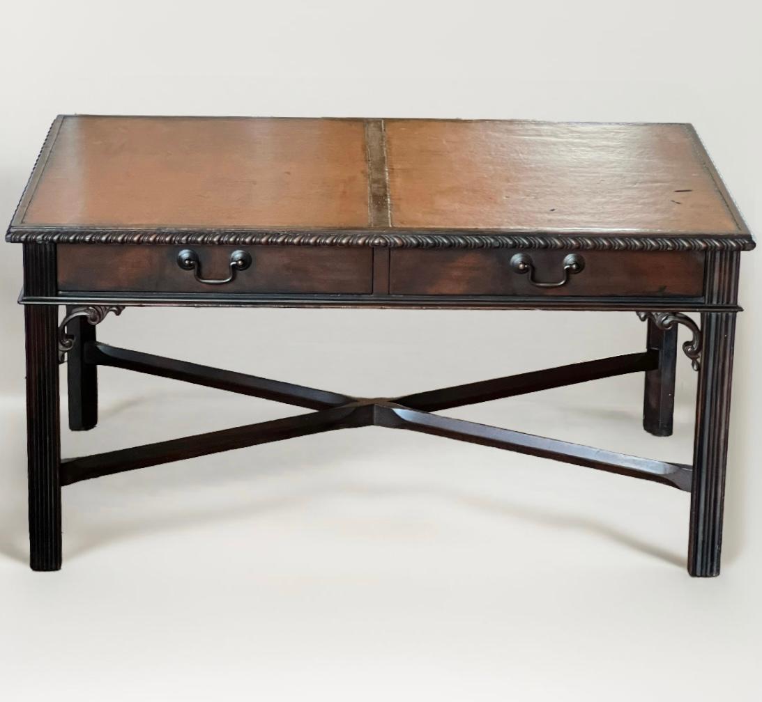 Stately mahogany Chippendale style coffee table by Imperial of Grand Rapids, c. 1940's.

A great table featuring a dual panel leather top and two dovetailed drawers with bronze finish hardware. Finely detailed with carved scroll work, square fluted