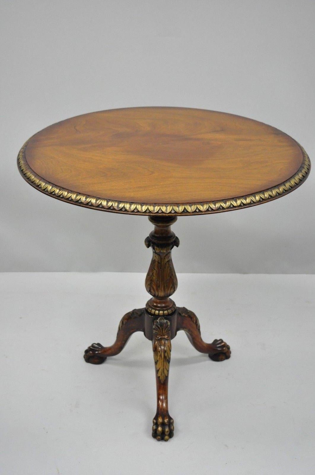 High quality vintage mahogany Chippendale style pie crust tilt-top tea table. Item features Acanthus leaf carvings, gold painted accents, shell carved knees, solid wood construction, beautiful wood grain, carved paw feet, and quality American