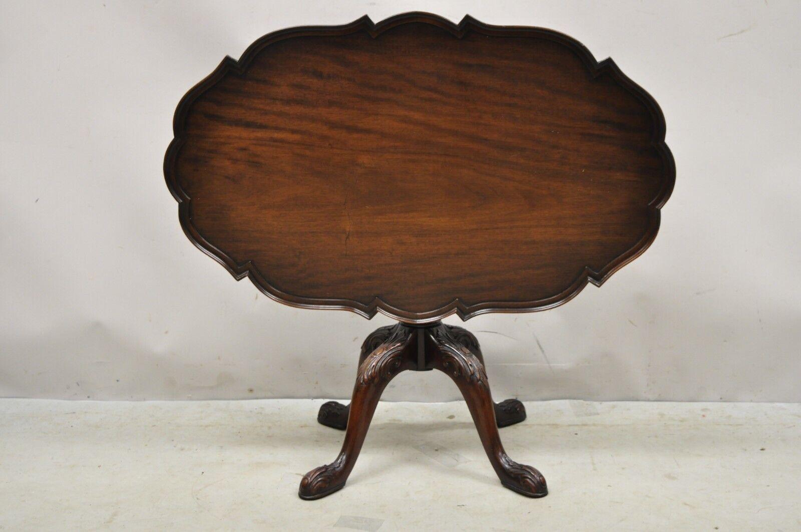 Vintage Mahogany Chippendale Style Tilt Top Pedestal Base Scalloped Oval Coffee Table. Item features a tilt top, beautiful wood grain, nicely carved details, very nice vintage item, quality American craftsmanship, great style and form. Circa Early