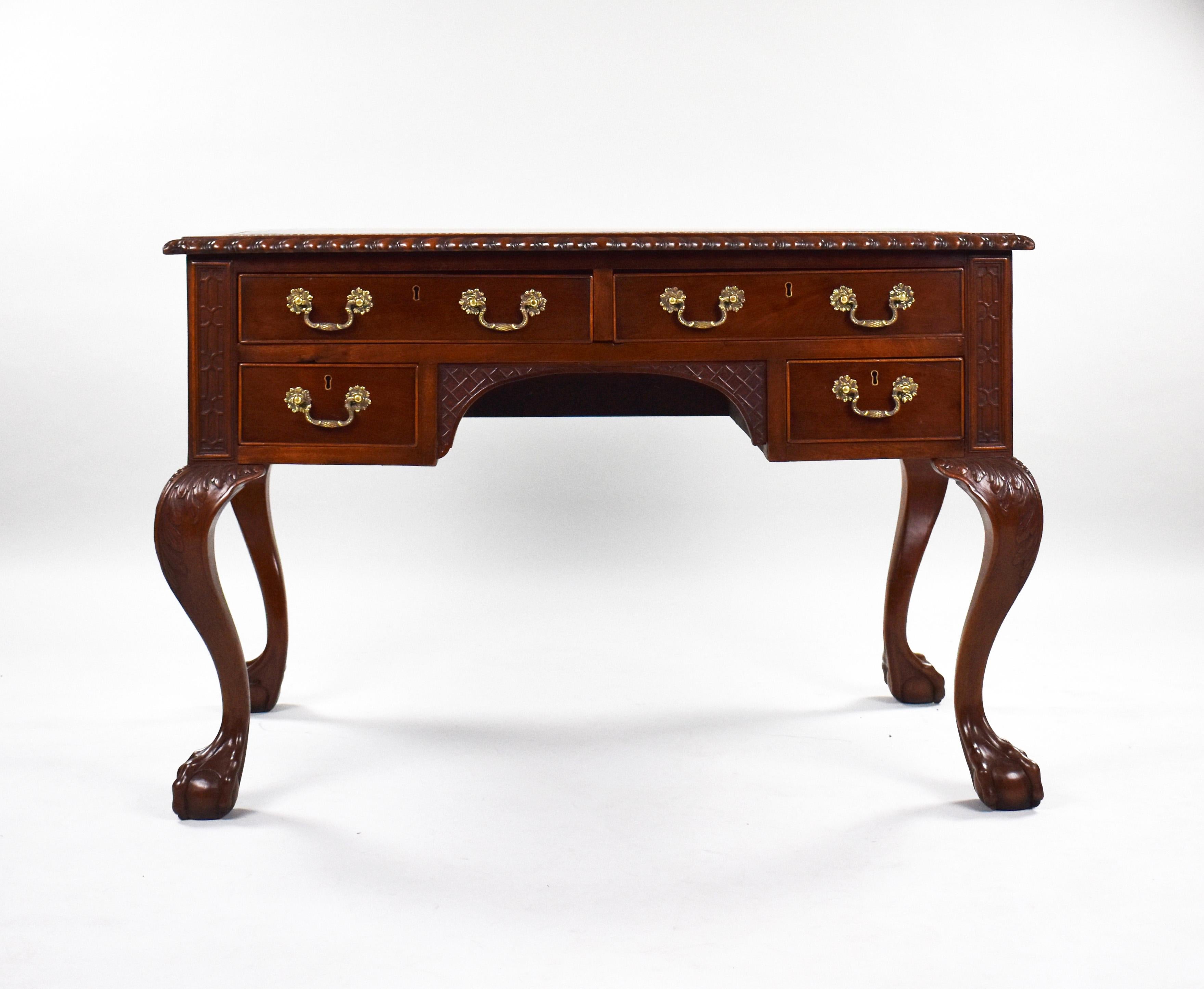 19th Century mahogany chippendale style writing table in good condition, having been polished by hand. The desk has a rope edge with a new tan leather with gold tooling to the outer edge. The desk has two long drawers to the top and to short drawers