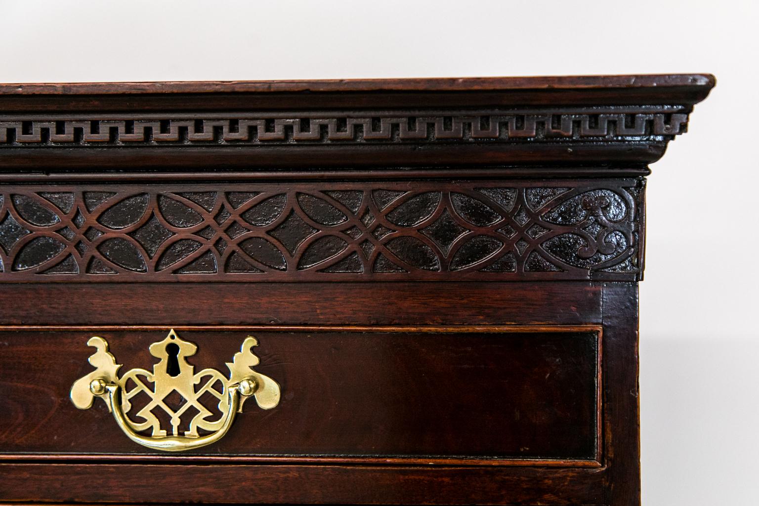 This English mahogany Chippendale tall chest has crown molding featuring the 