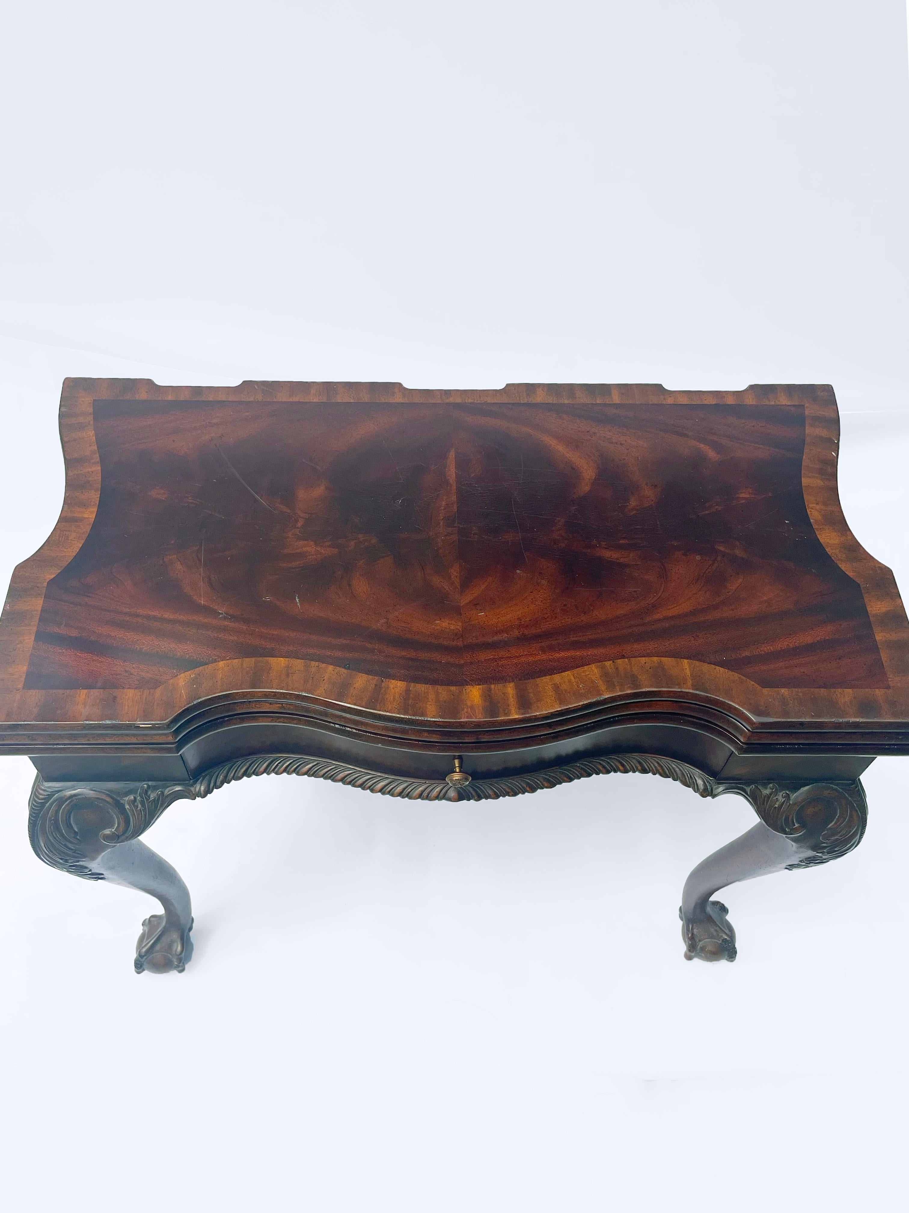 Beautiful Maitland-Smith game table with extra leg and leaf for conversion. Rich flame mahogany inlaid game table for checkers, chess or backgammon. A second top folds over to replace the game table with a faux tooled leather surface for cards or