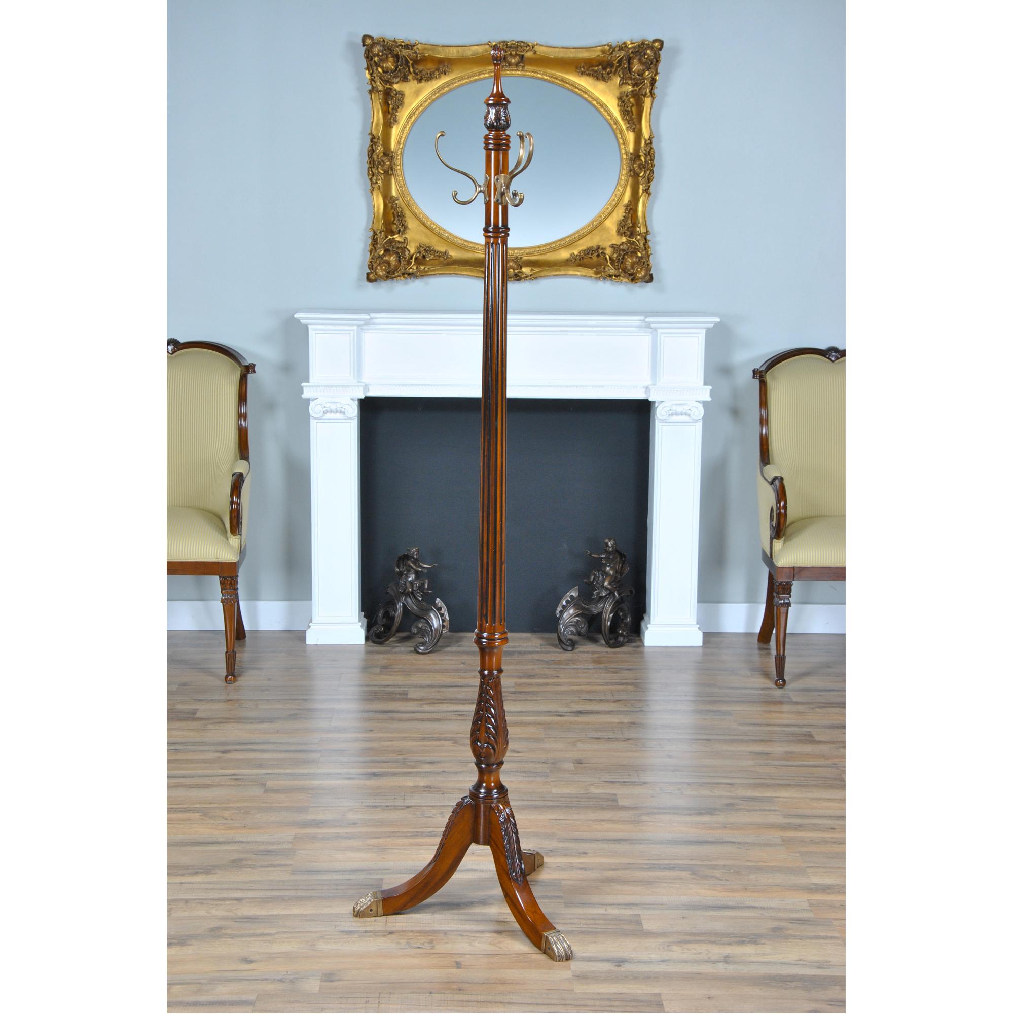 A Mahogany Coat Tree in Sheraton style features include solid mahogany construction with hand carved details throughout. The mahogany is harvested from plantation grown, sustainably harvested trees and the carvings are executed by our skilled
