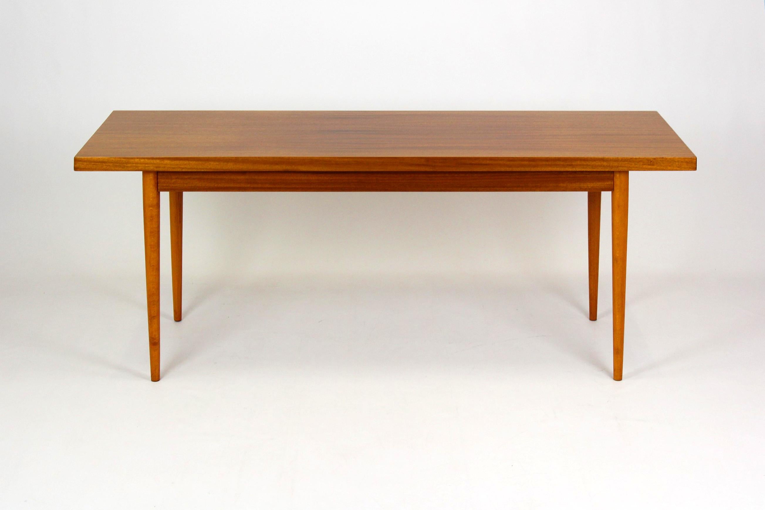 This Mid-Century Modern mahogany coffee table was manufactured in 1969 in the Czech Republic by UP Zavody. It is preserved in a very good, original condition. Legs can be unscrewed for easy shipping.