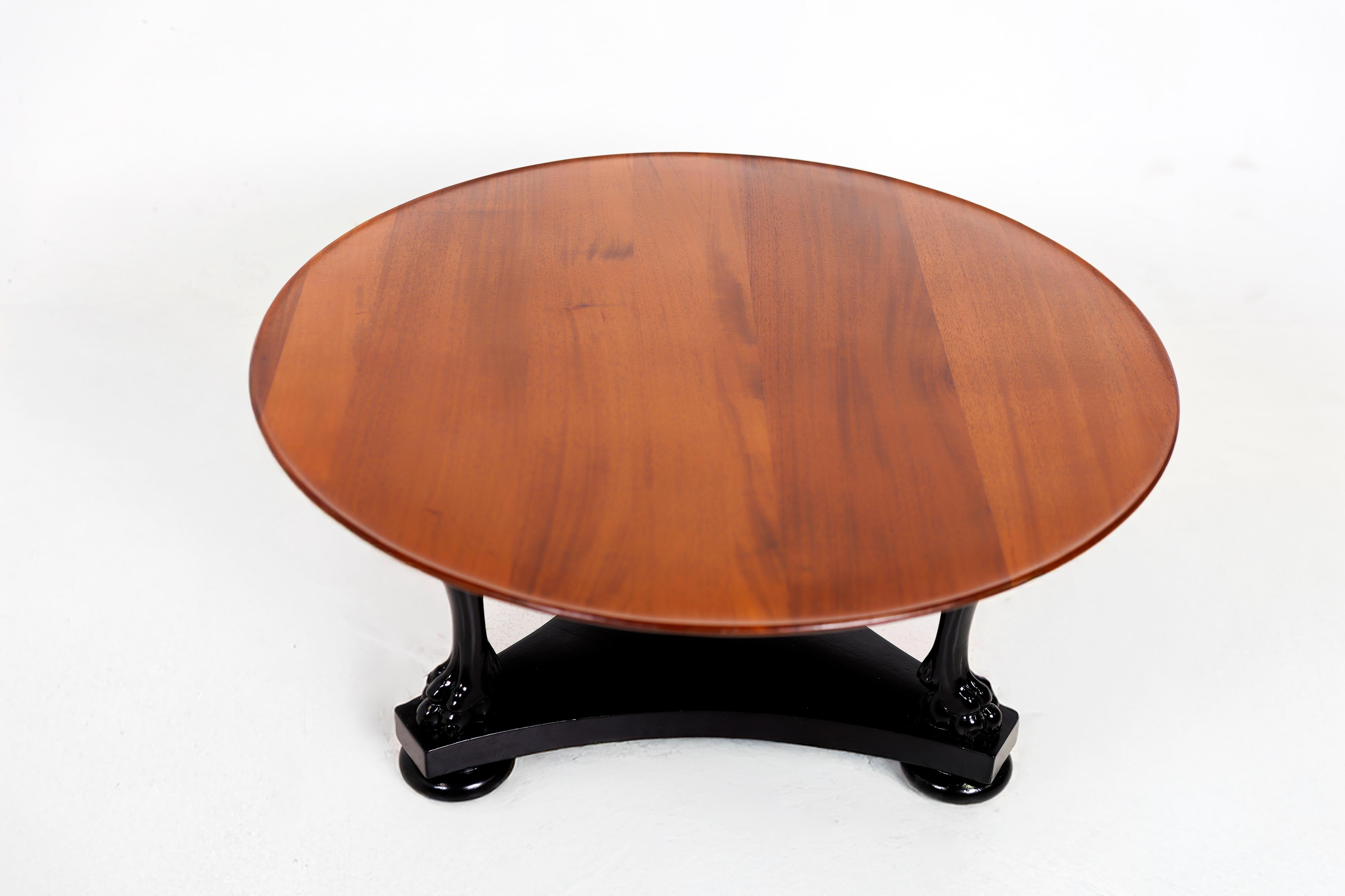 Mahogany Coffee Table with black lacquered Lion's Paws base. From the 1960's. Ready for a new home.