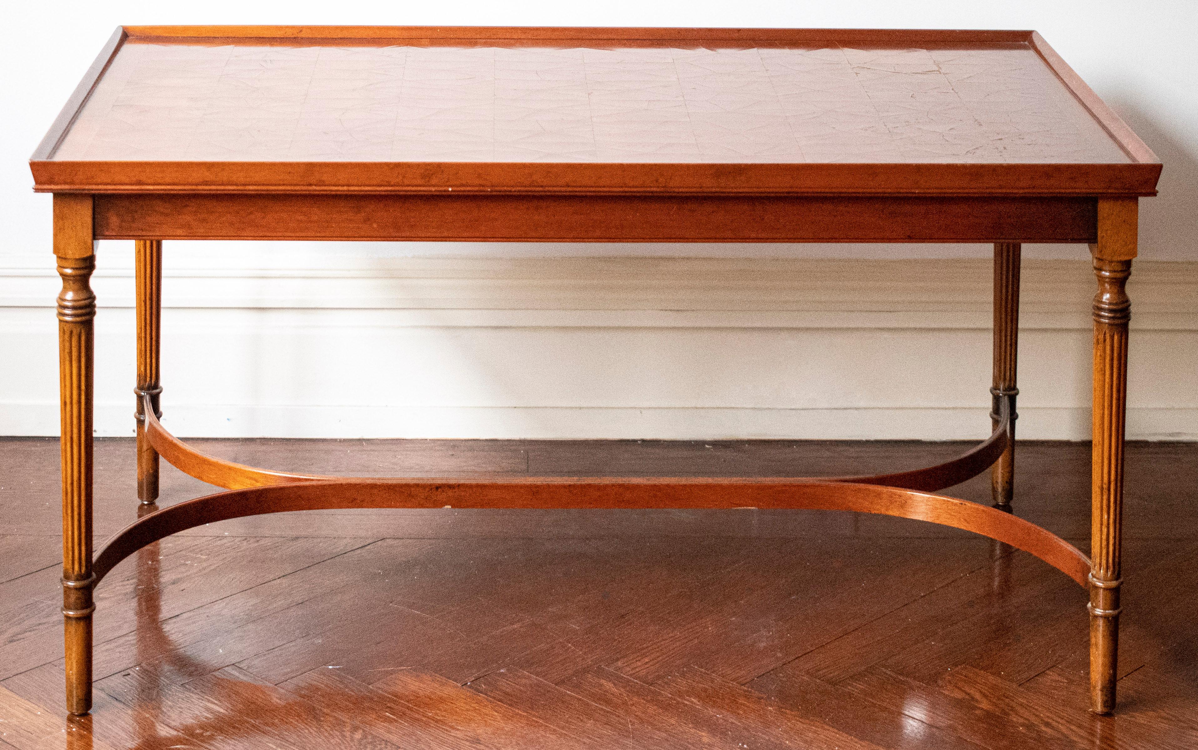 20th century mahogany coffee table, the rectangular top raised on fluted legs with demilune stretchers. Measures: 19.5