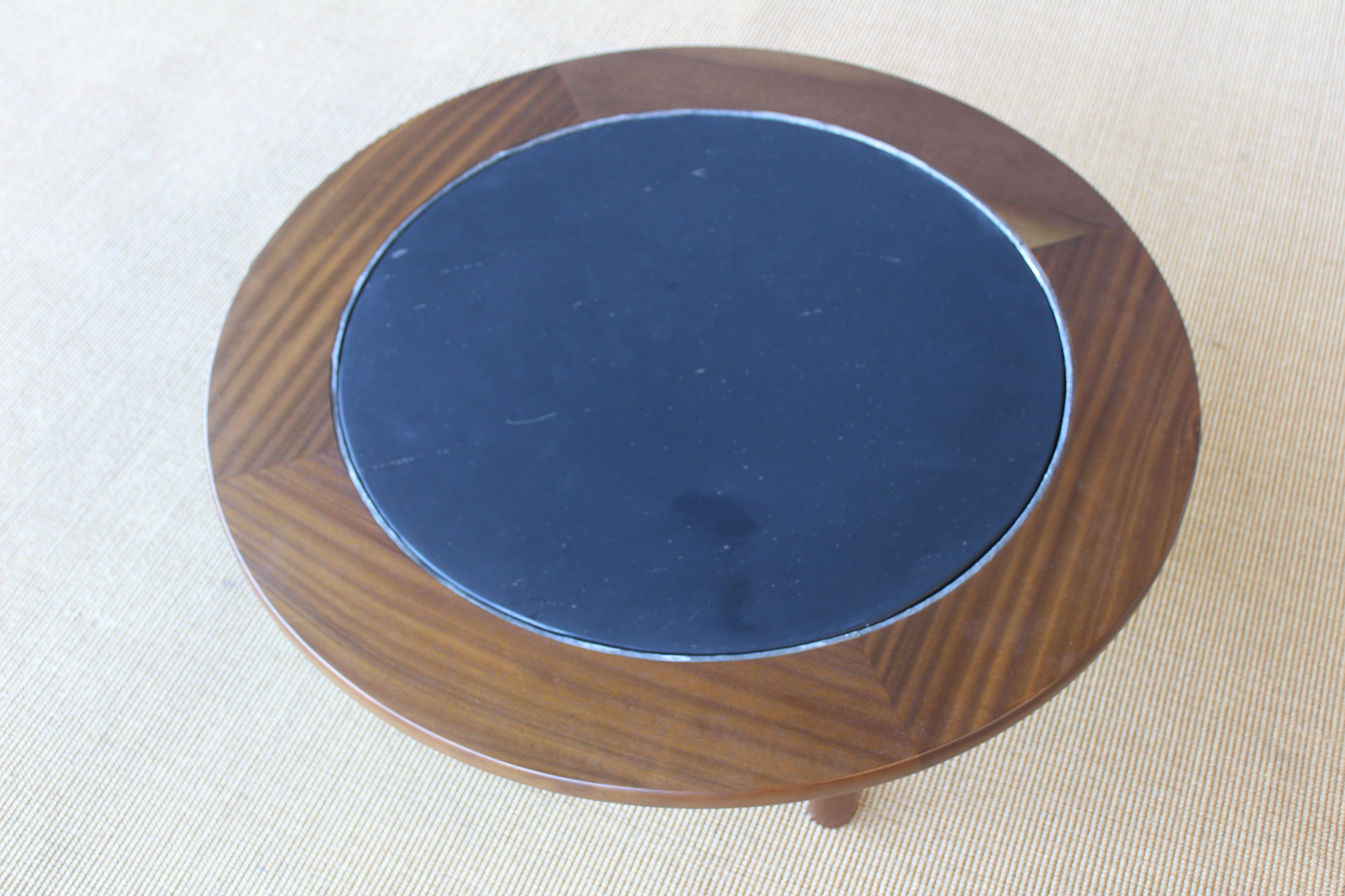 Mahogany coffee table with a slate inserted top. France, 1960s. Base has been recently refinished. Slate top shows some natural imperfections.