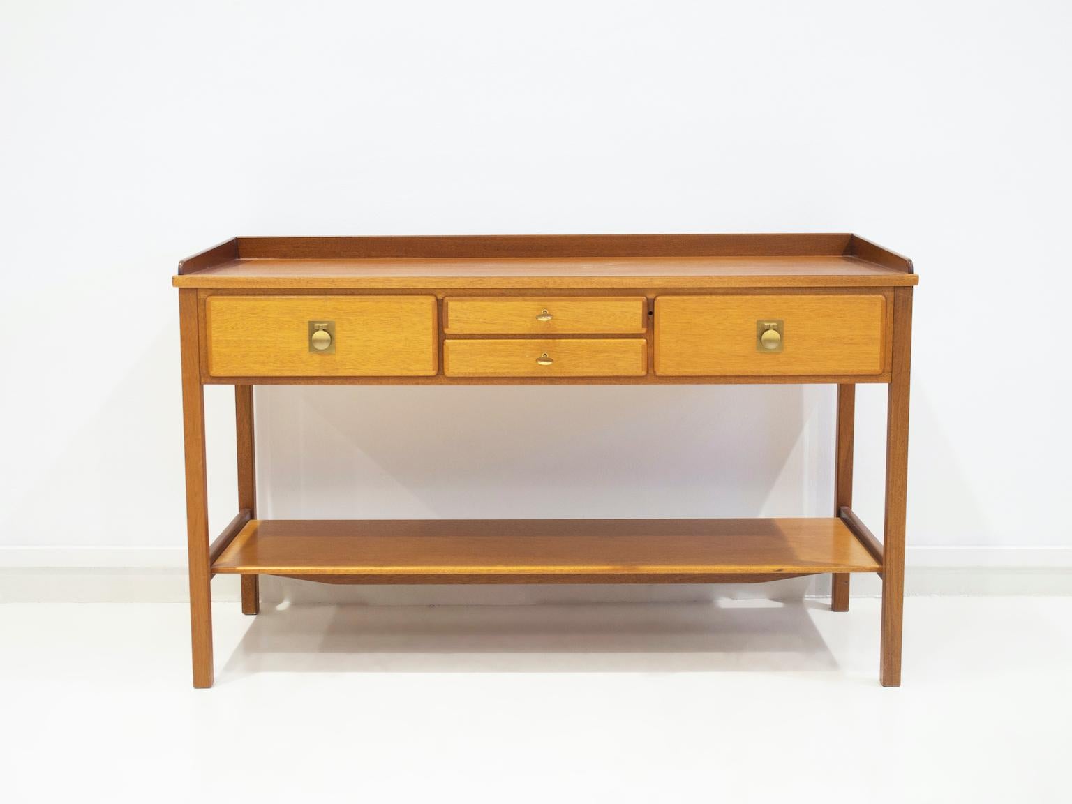 Mahogany console table or sideboard manufactured by Nordiska Kompaniet, circa 1960's. Elegant piece with four drawers, brass fittings and top with slightly raised edge. Keys included.

No Cites needed.