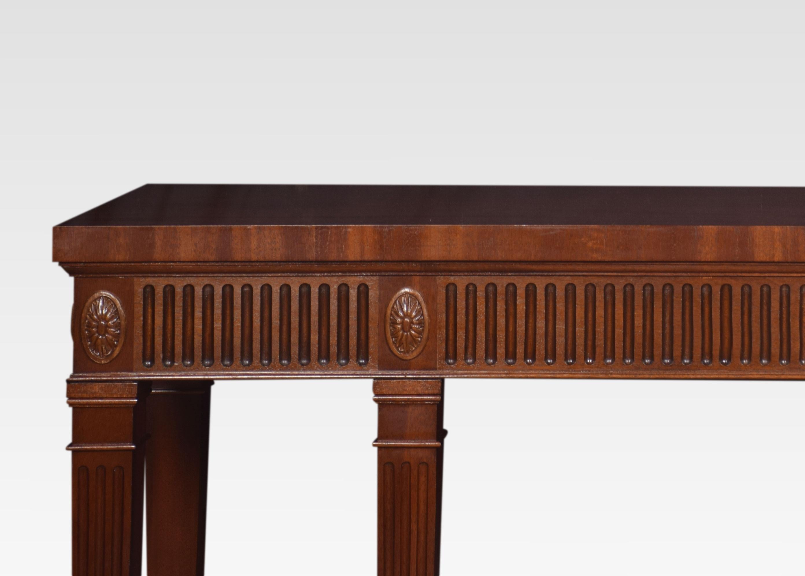 Mahogany console table the large rectangular well figured top above a fluted and paterae applied apron. All raised on six square tapered and fluted legs ending in block feet.
Dimensions
Height 35.5 inches
Width 66 inches
Depth 18.5 inches.