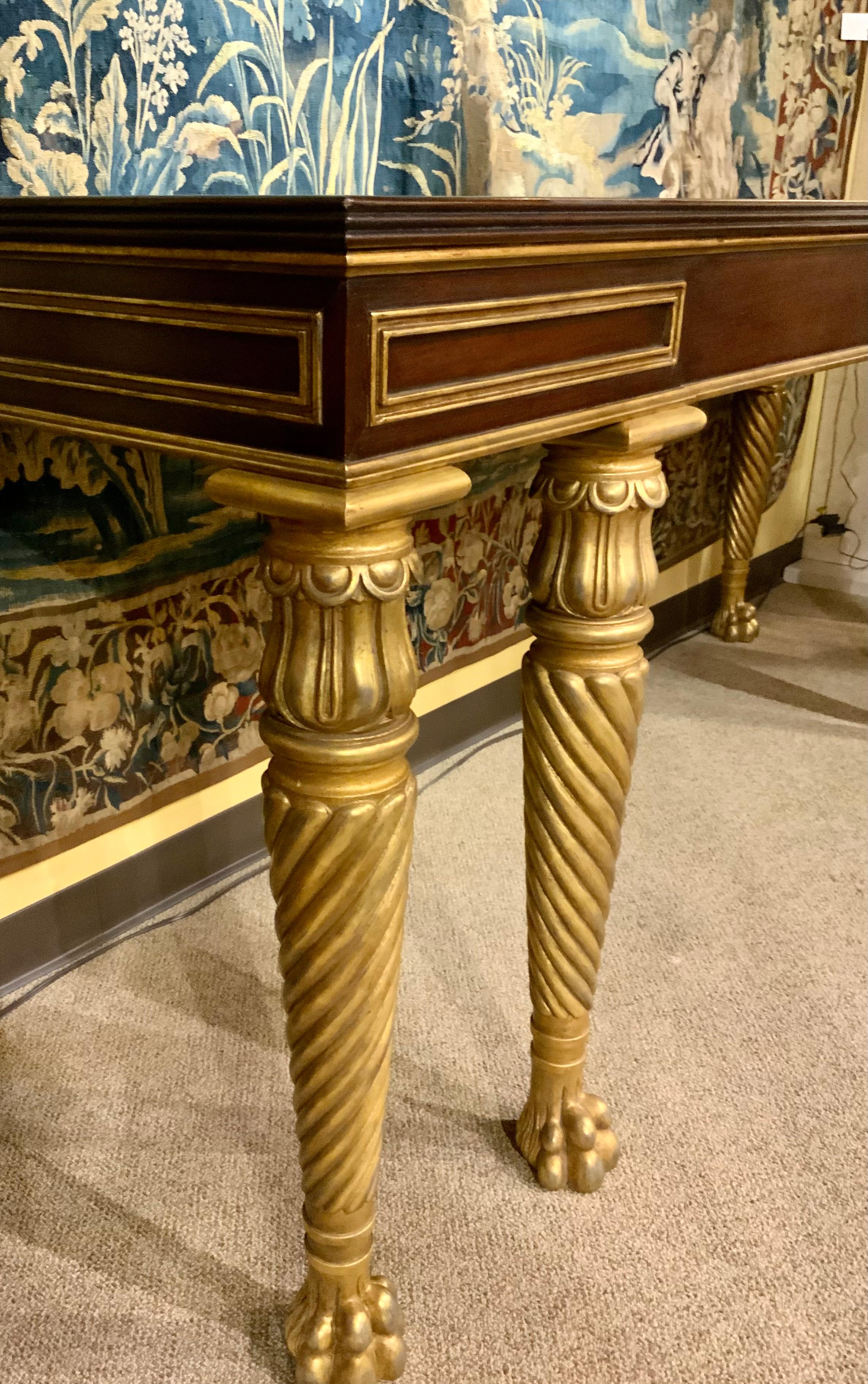 Mahogany wood in impeccable condition make this piece desirable.
It is in the Baltic neoclassical-style with parcel gilt wood. It is mid-century
With a rectangular top above a frame accented with various gilt 
Geometric moldings, raised on gilt