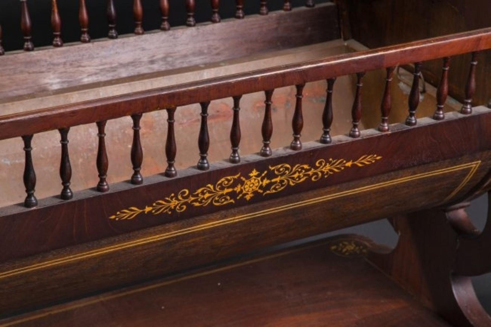 Louis Philippe or North European neoclassical fruitwood inlaid mahogany cradle, 
mid-19th century, the half round cradle now fitted with a removable copper liner, with spindle turned frieze supported on lyre-form ends and a platform base containing
